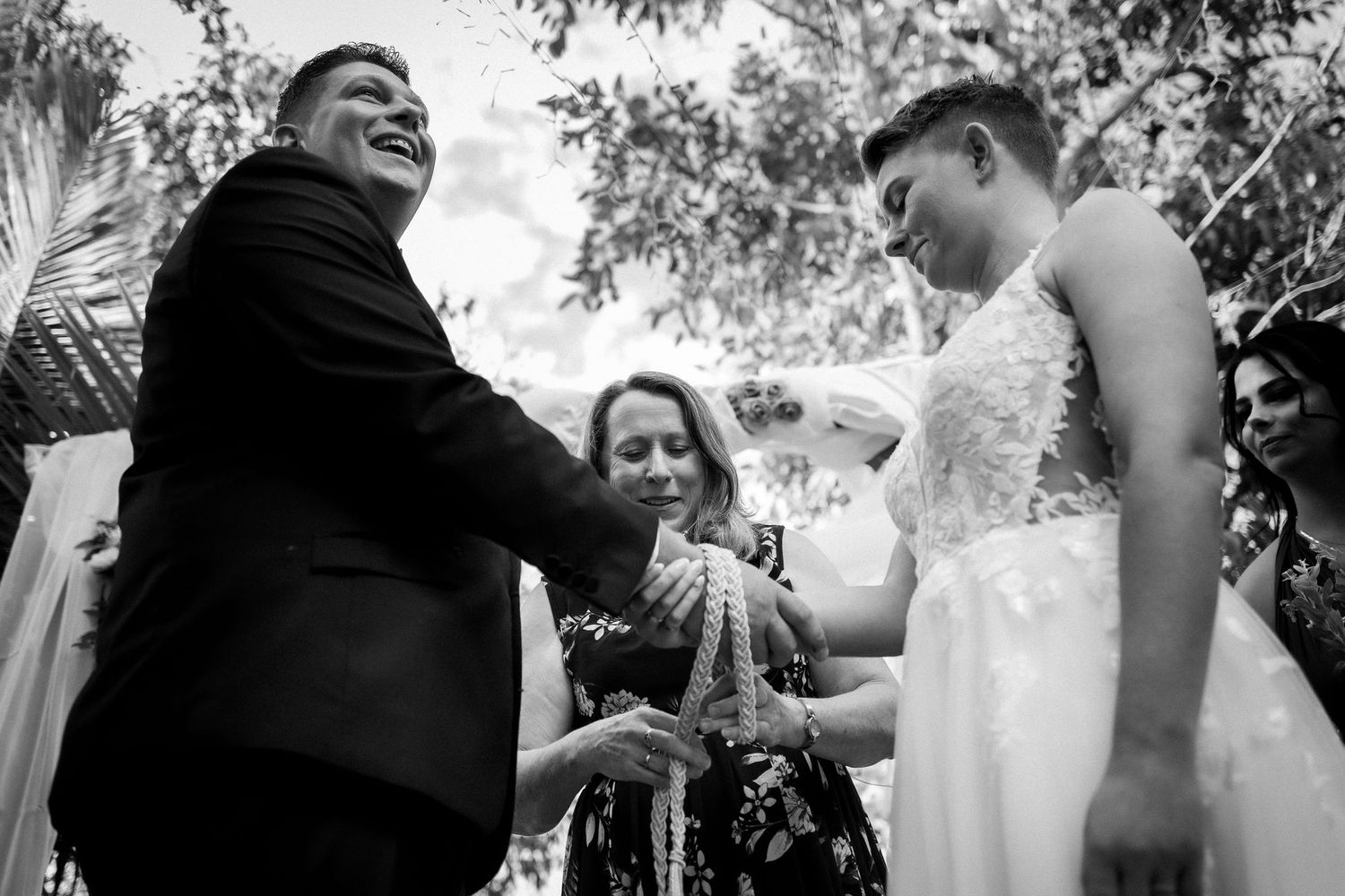 Candid moments of laughter and joy during outdoor wedding festivities.