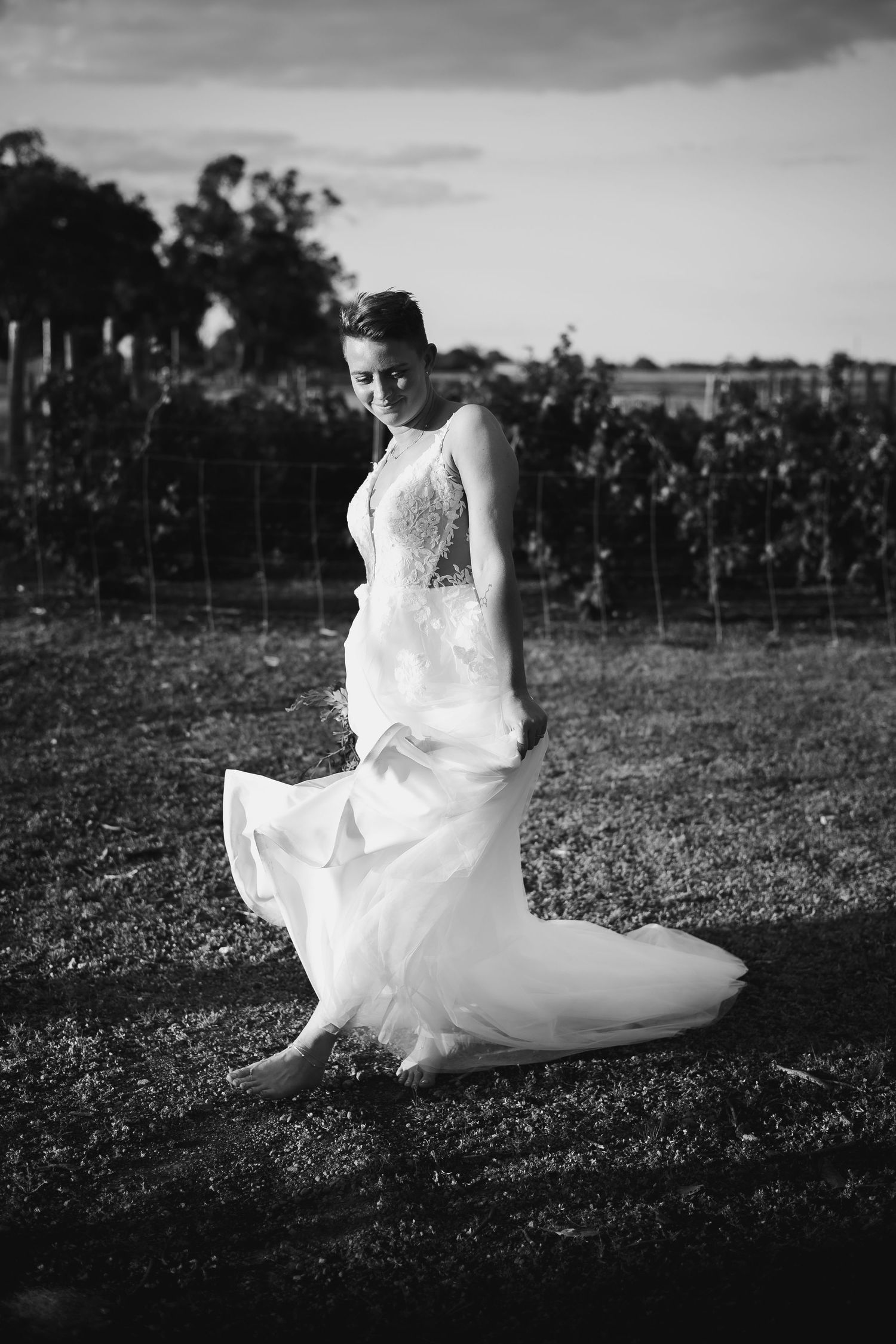 Black and white artistic shots of flowing wedding dress in rustic outdoor setting.