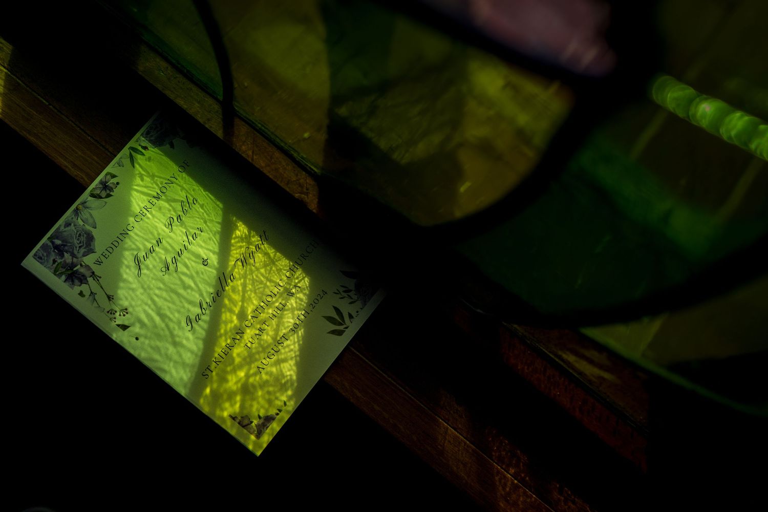 Abstract green geometric patterns and shapes illuminated against a dark background.