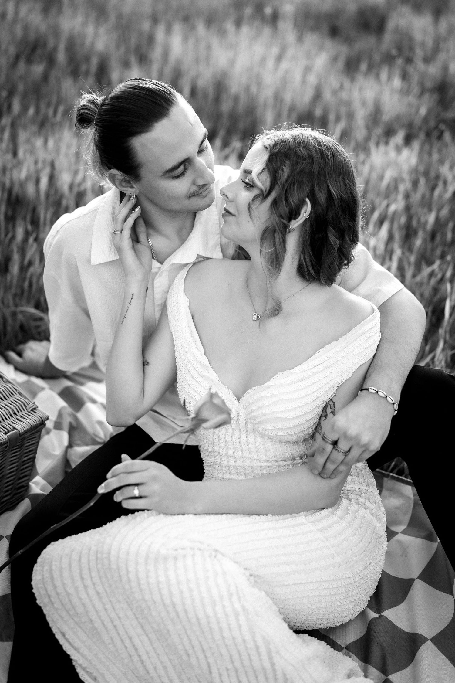 Black and white photo of a couple sharing a romantic moment during a picnic in a field. at Guildford, Perth