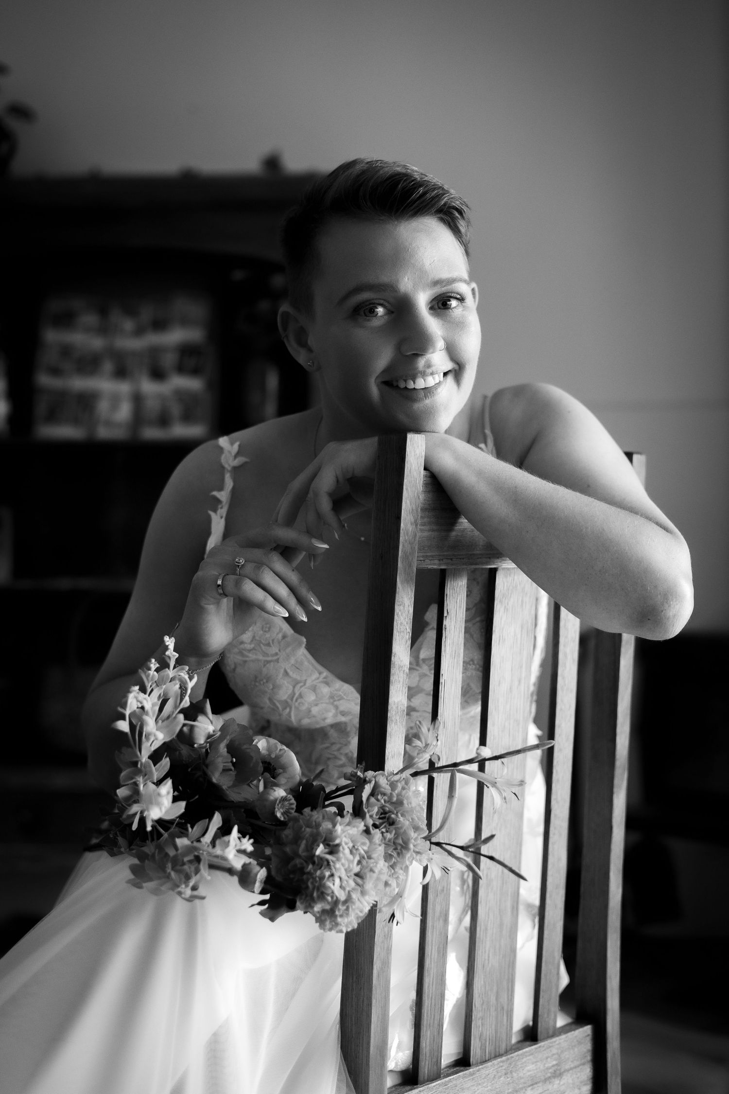 An intimate black and white wedding portrait featuring a beautiful floral bouquet.