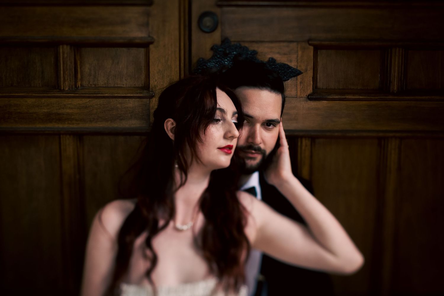 Intimate portrait session in dark wood-paneled interior setting.
