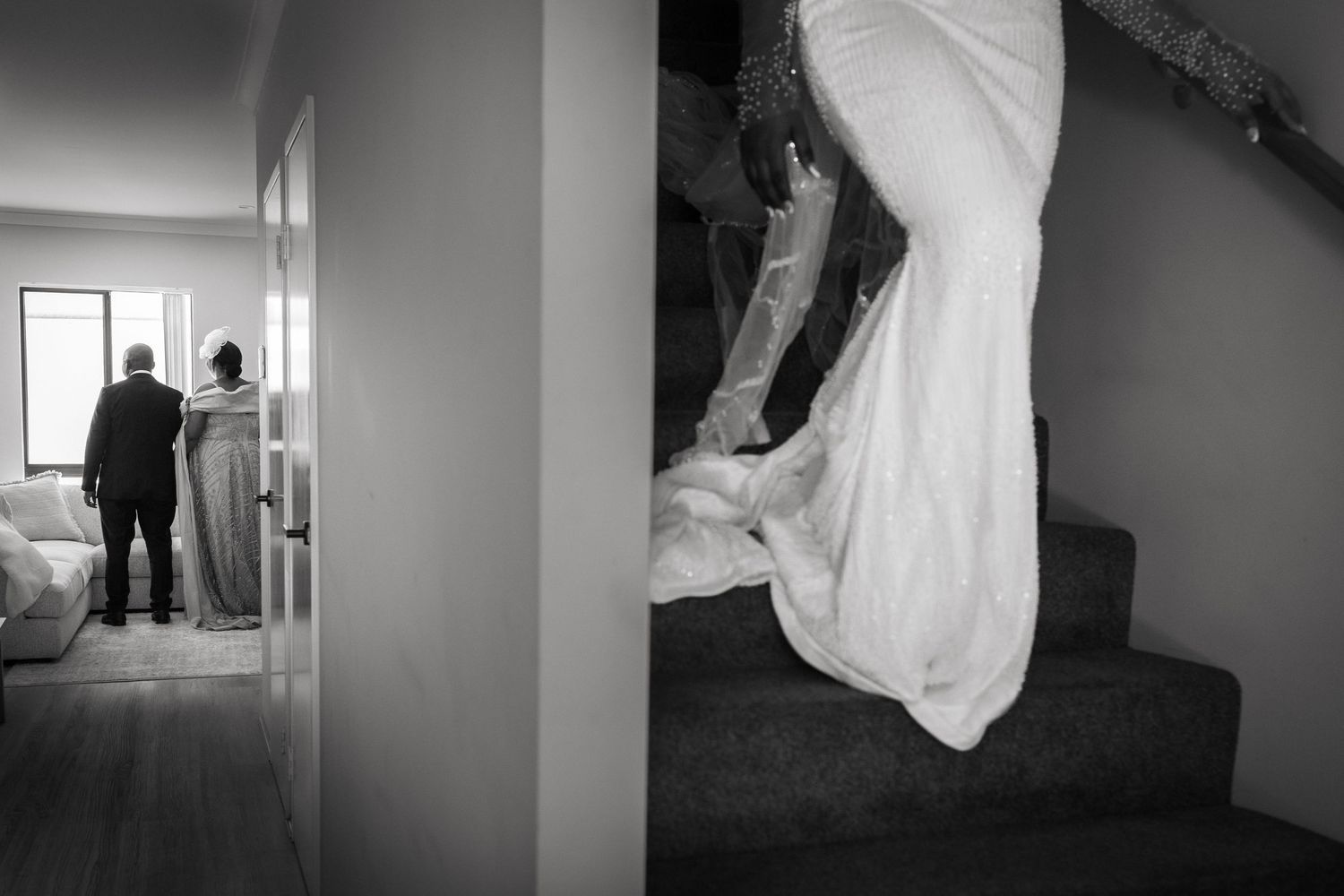 Black and white wedding photo diptych showing bride descending stairs in gown and couple standing by window.