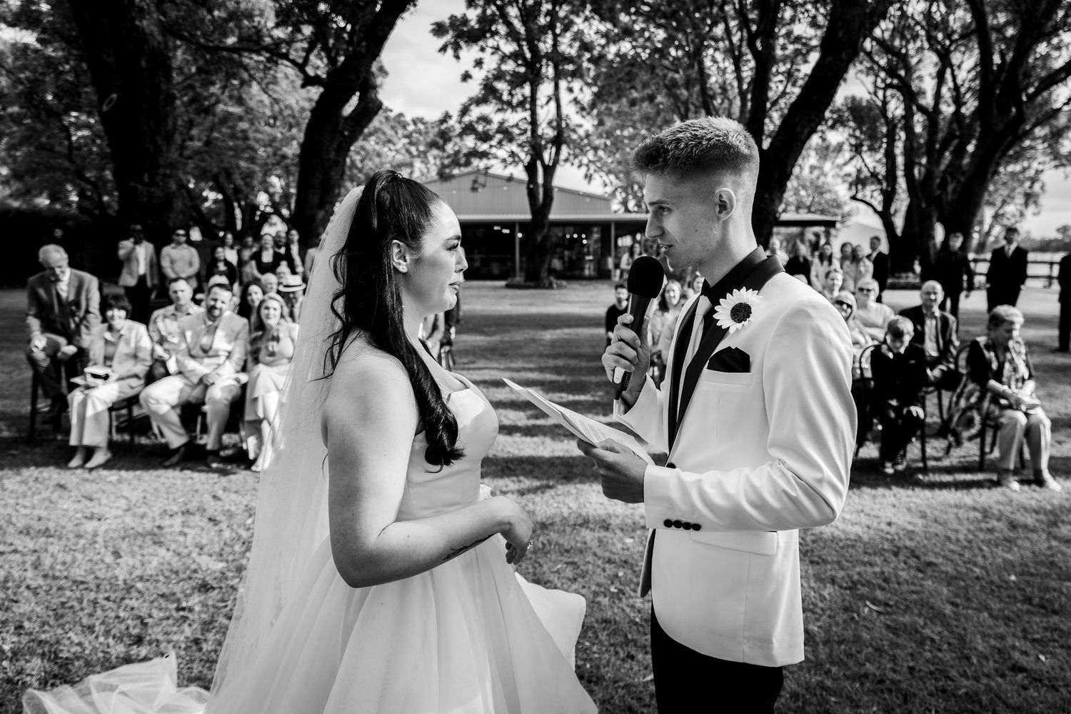 Wedding guests dance and celebrate on an outdoor patio during a reception celebration.