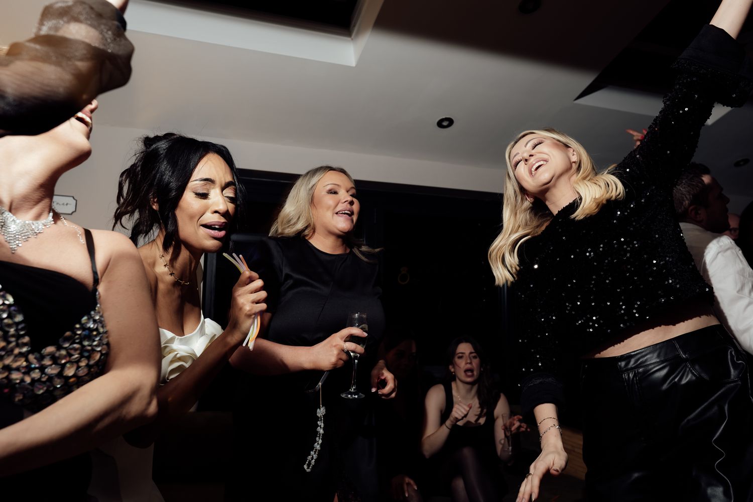 People dancing and having fun at a dimly lit nightclub event.
