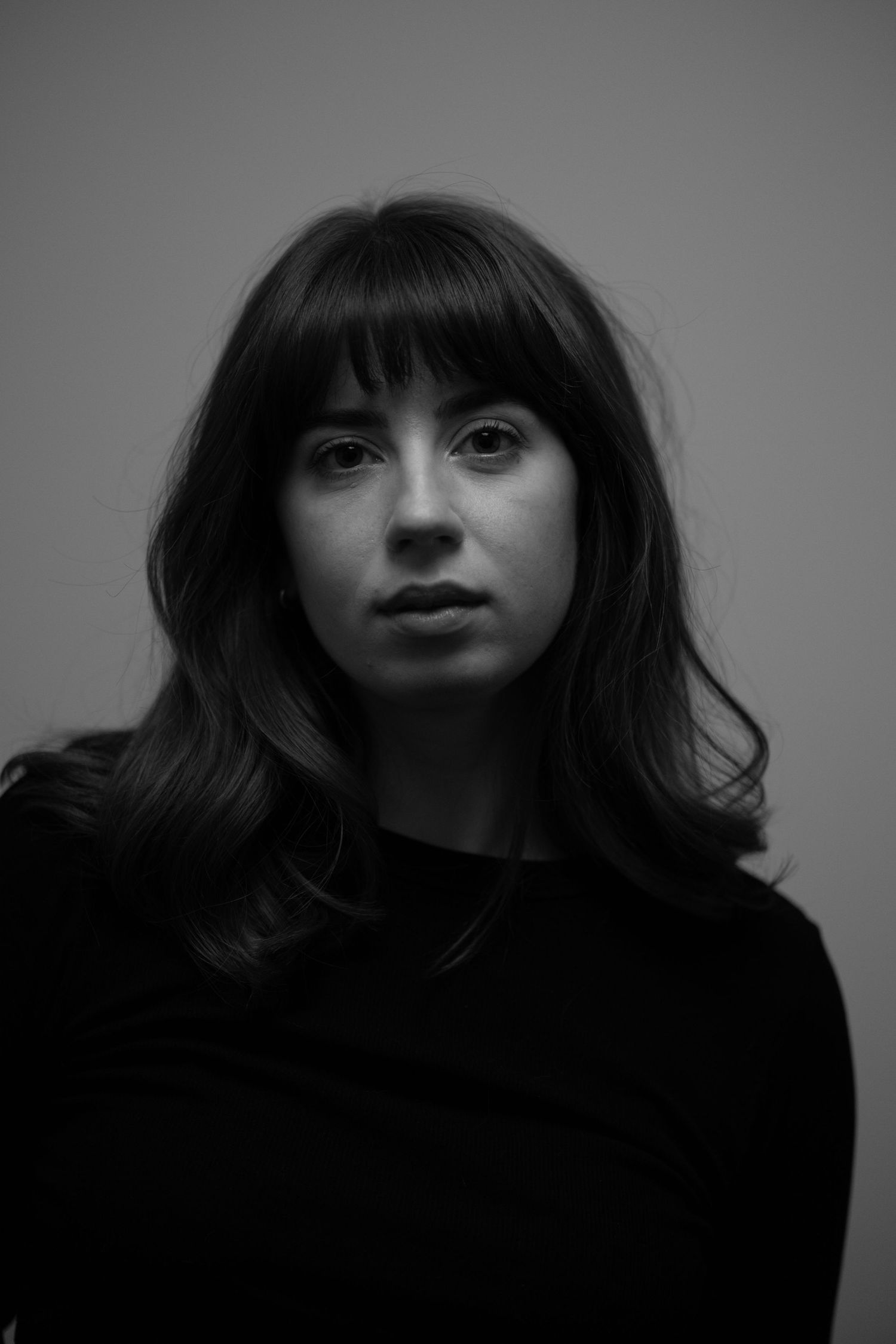 A series of dramatic black and white portraits showing expressive poses against a dark background.