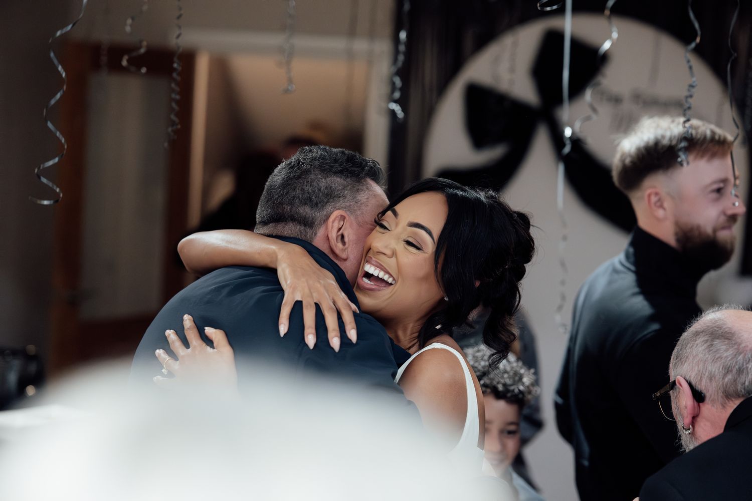 An emotional embrace captured during a wedding celebration.