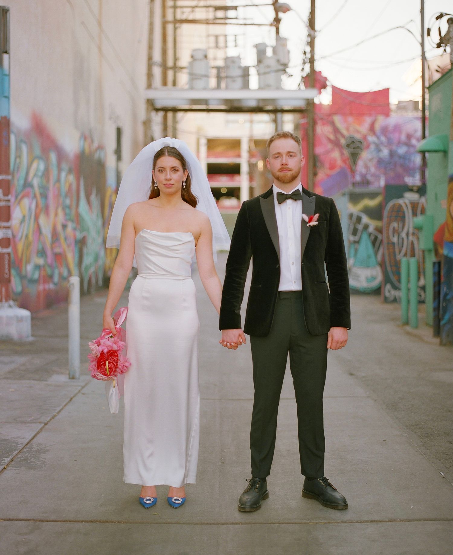 Artistic wedding photography sequence showing couple's feet in urban alley with colorful graffiti backdrop.