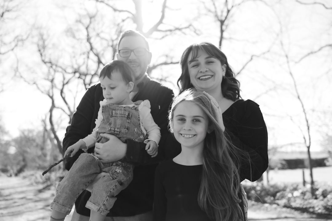 A series of black and white family photos arranged in a horizontal strip showing outdoor moments together.