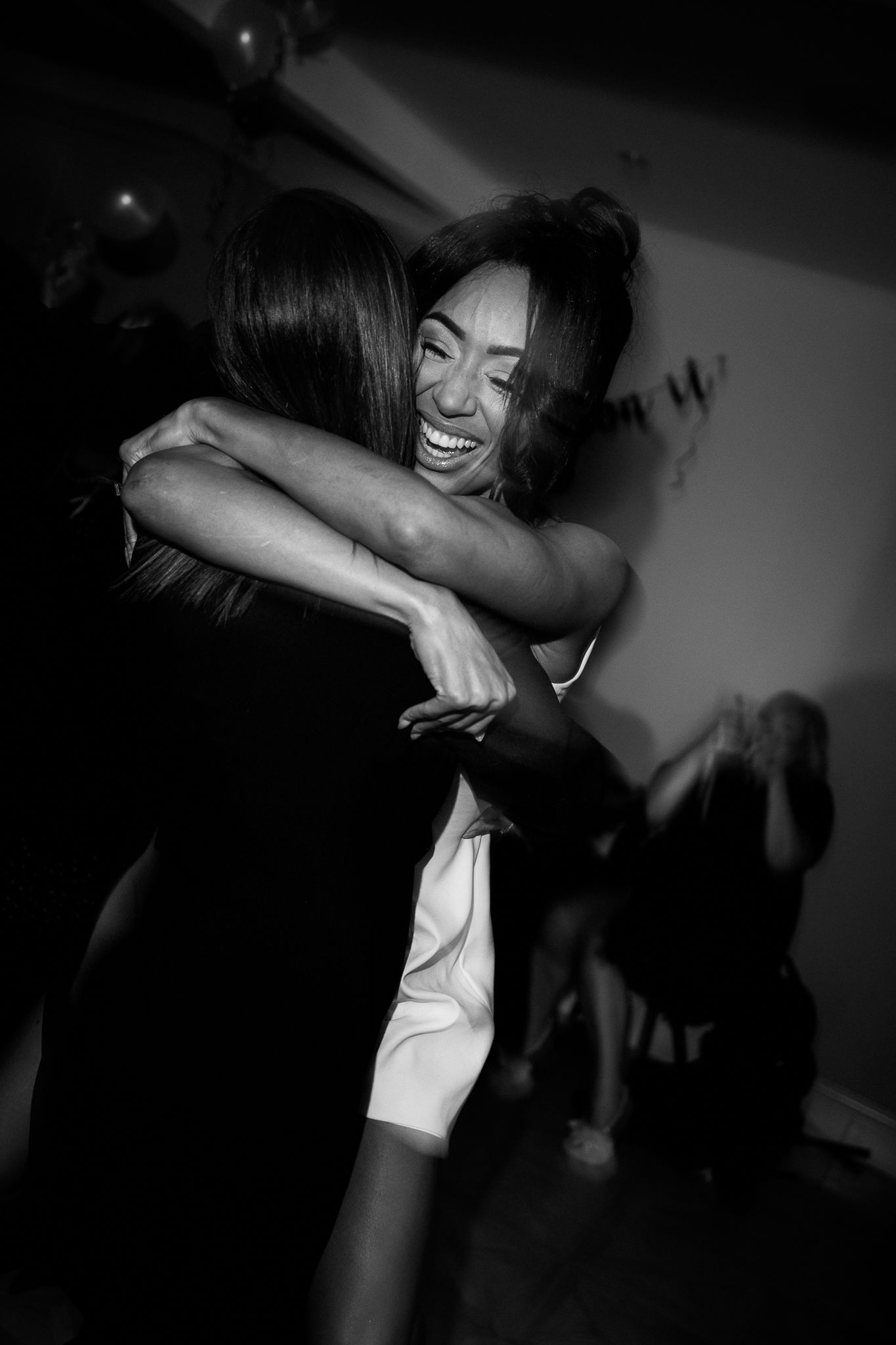 Black and white photo series showing energetic dance movements in a dark room with dramatic lighting and shadows.