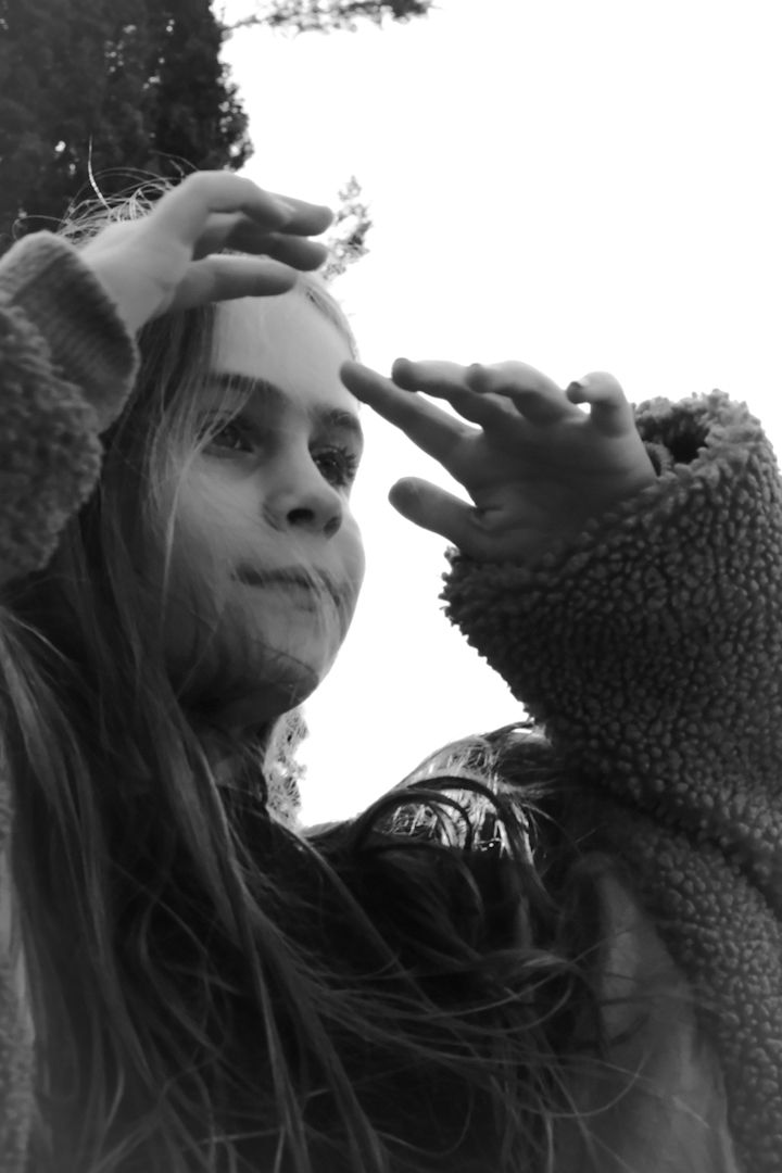 Artistic black and white close-up portraits showing dramatic angles and textured fabric details.