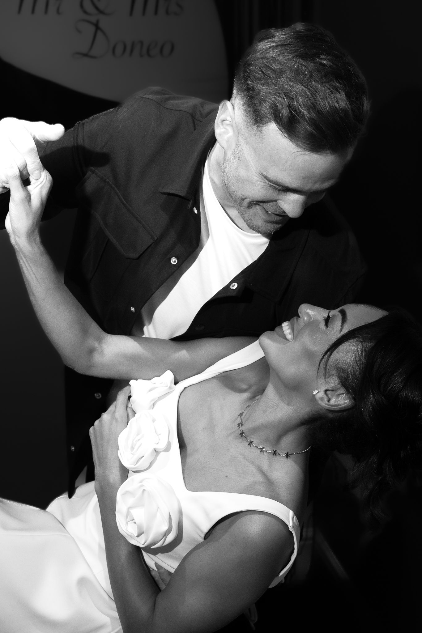 A romantic black and white photo series showing a couple dancing together in an intimate tango pose.