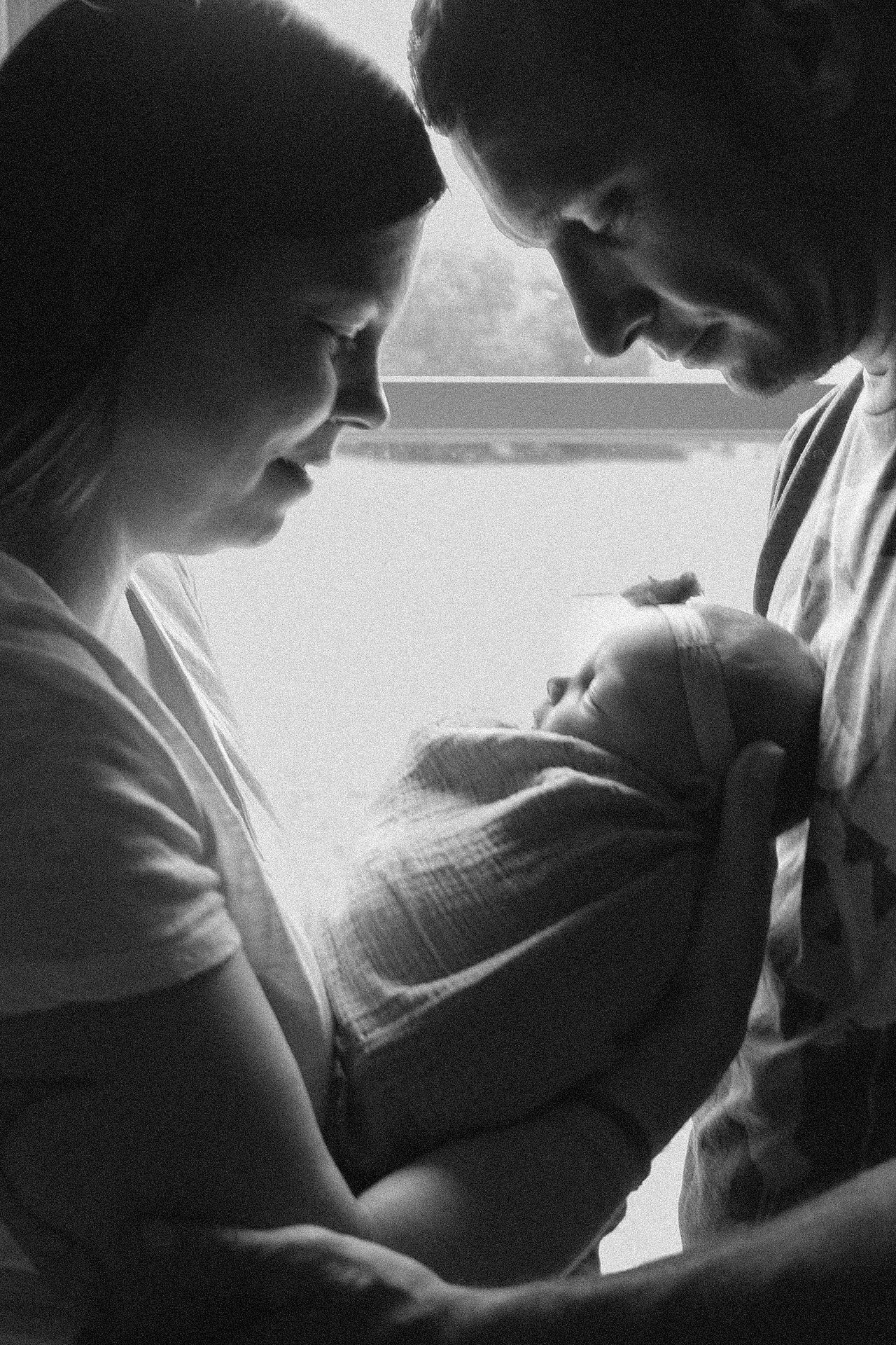 Black and white silhouette of tender nurturing moment.