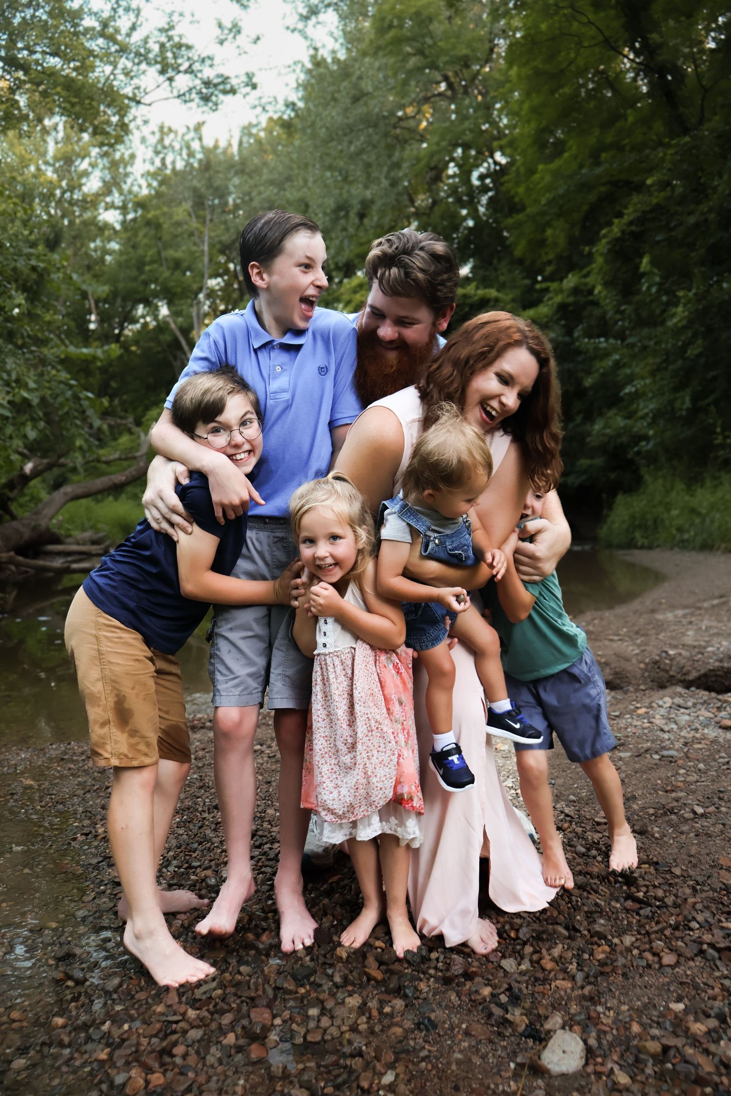 Candid moments of a family laughing together by the water's edge.