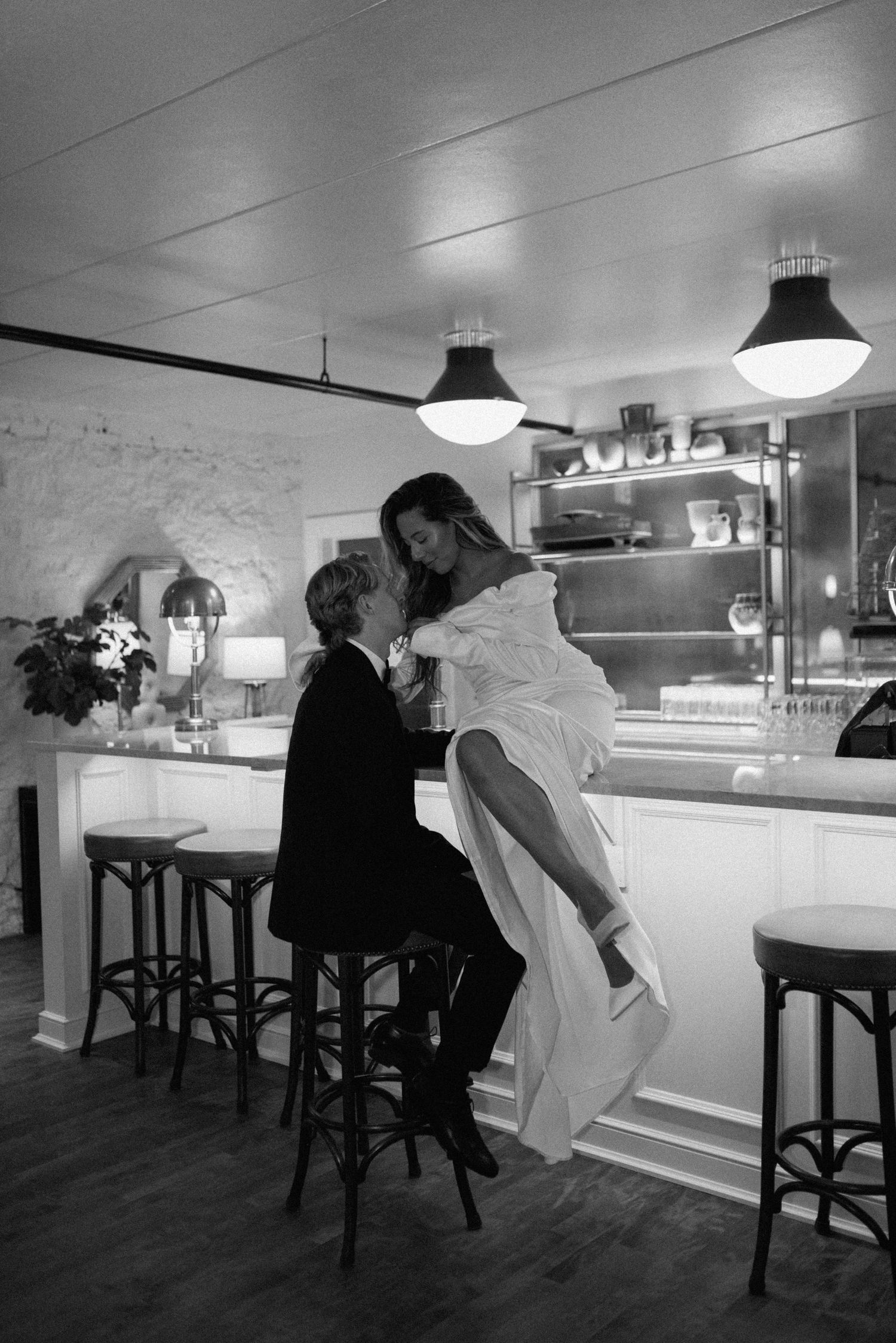 Black and white portrait of a romantic dance moment at a bar counter. Appleton, Green Bay & Kaukauna