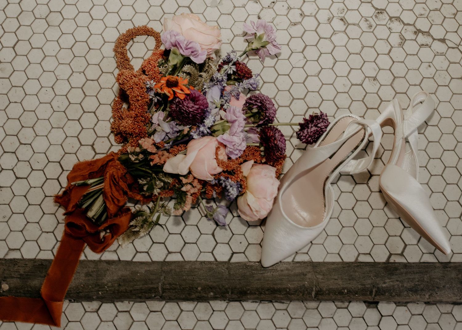 Decorative floral arrangement on hexagonal tile floor. Appleton, Green Bay & Kaukauna