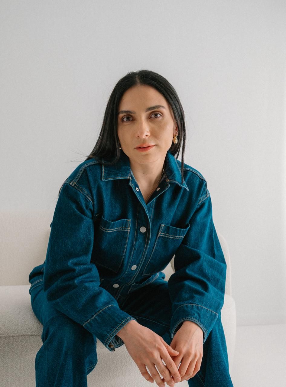 Series of minimal studio portraits showing a person wearing an oversized denim jacket against a white background.