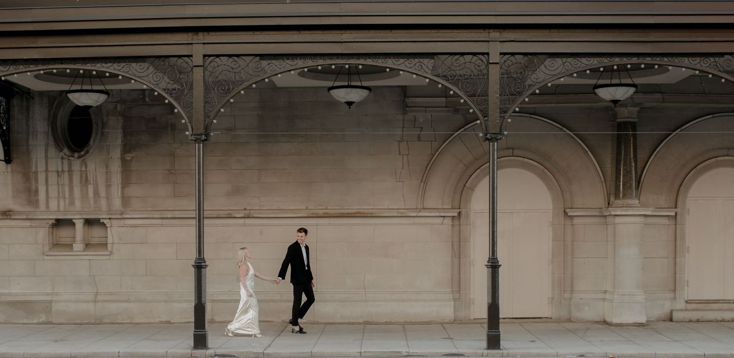 Architectural corridor with arches and columns creating dramatic shadows and perspective.