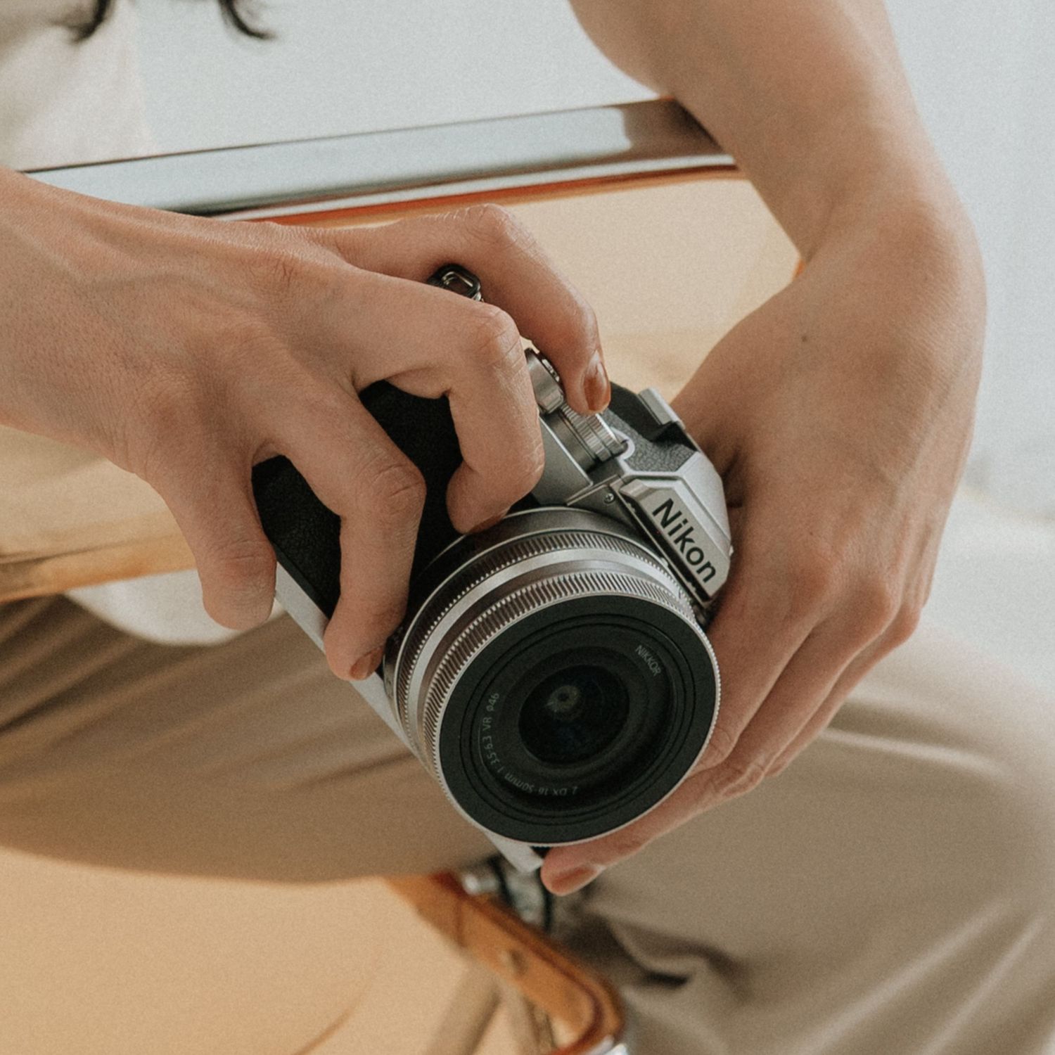 Close up of hands holding and adjusting a camera lens. Appleton, Green Bay & Kaukauna