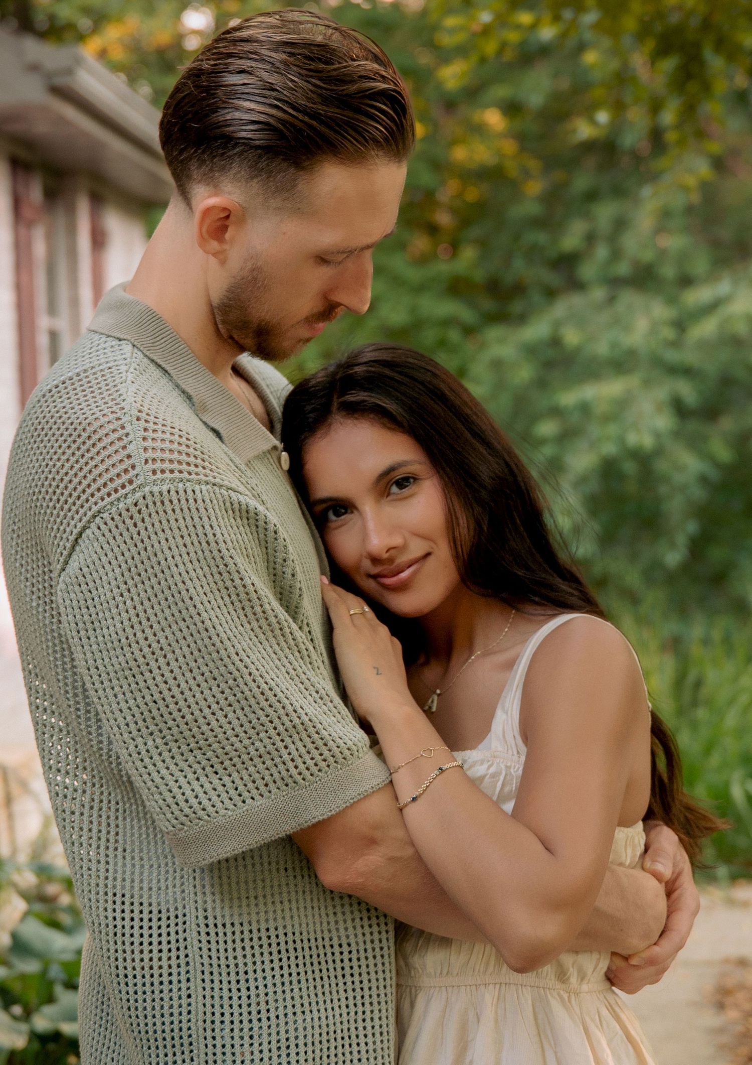 Intimate portrait of couple in casual attire against natural backdrop. Appleton, Green Bay & Kaukauna