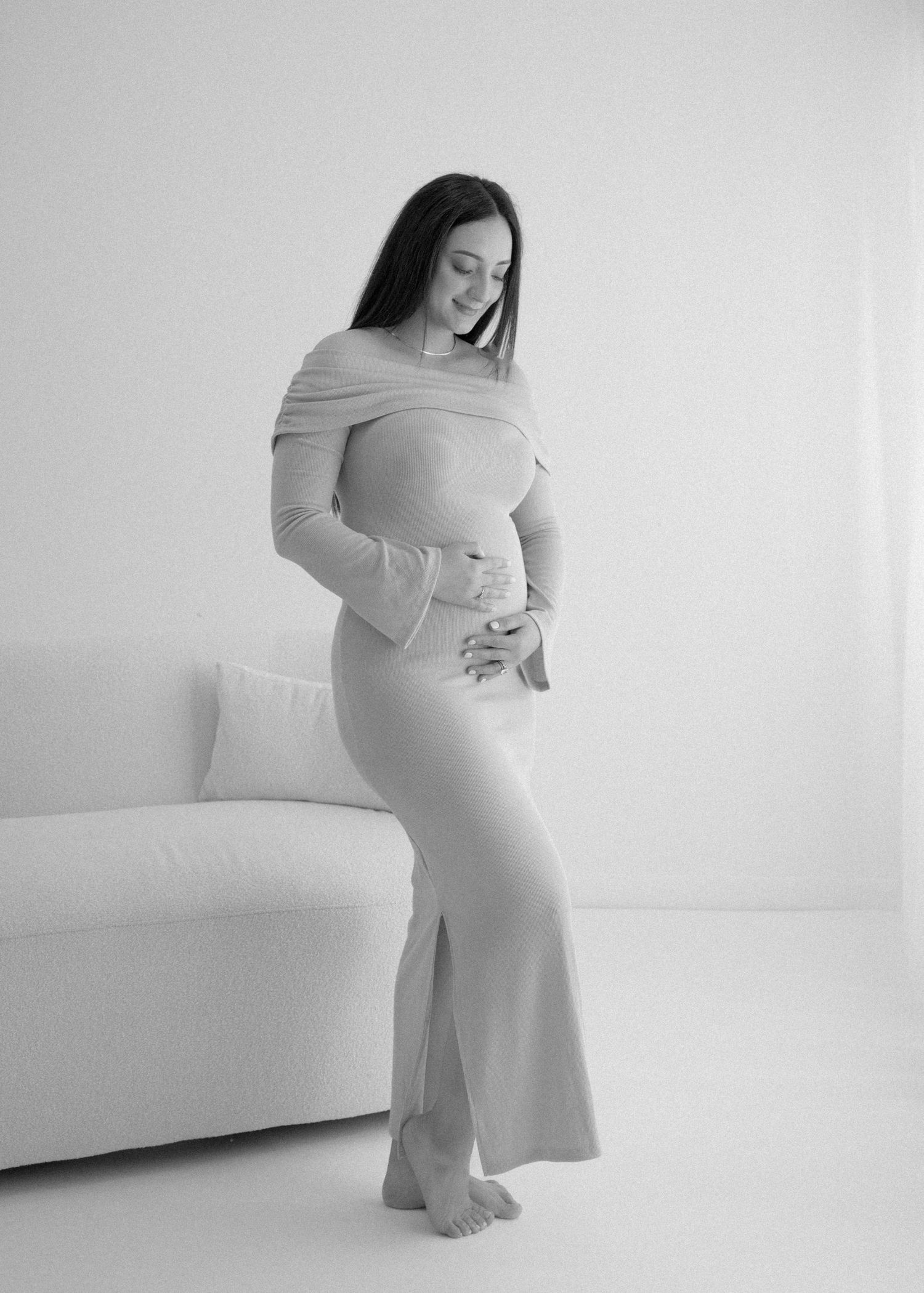 Minimalist maternity photo series in soft neutral tones against white backdrop.