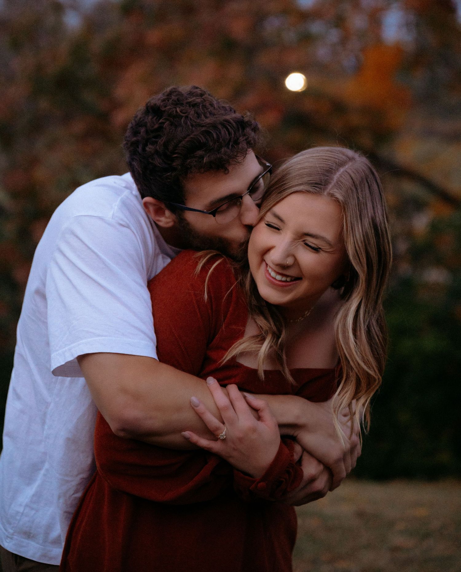 Intimate candid moments shared between couple during golden hour autumn photoshoot. Appleton, Green Bay & Kaukauna
