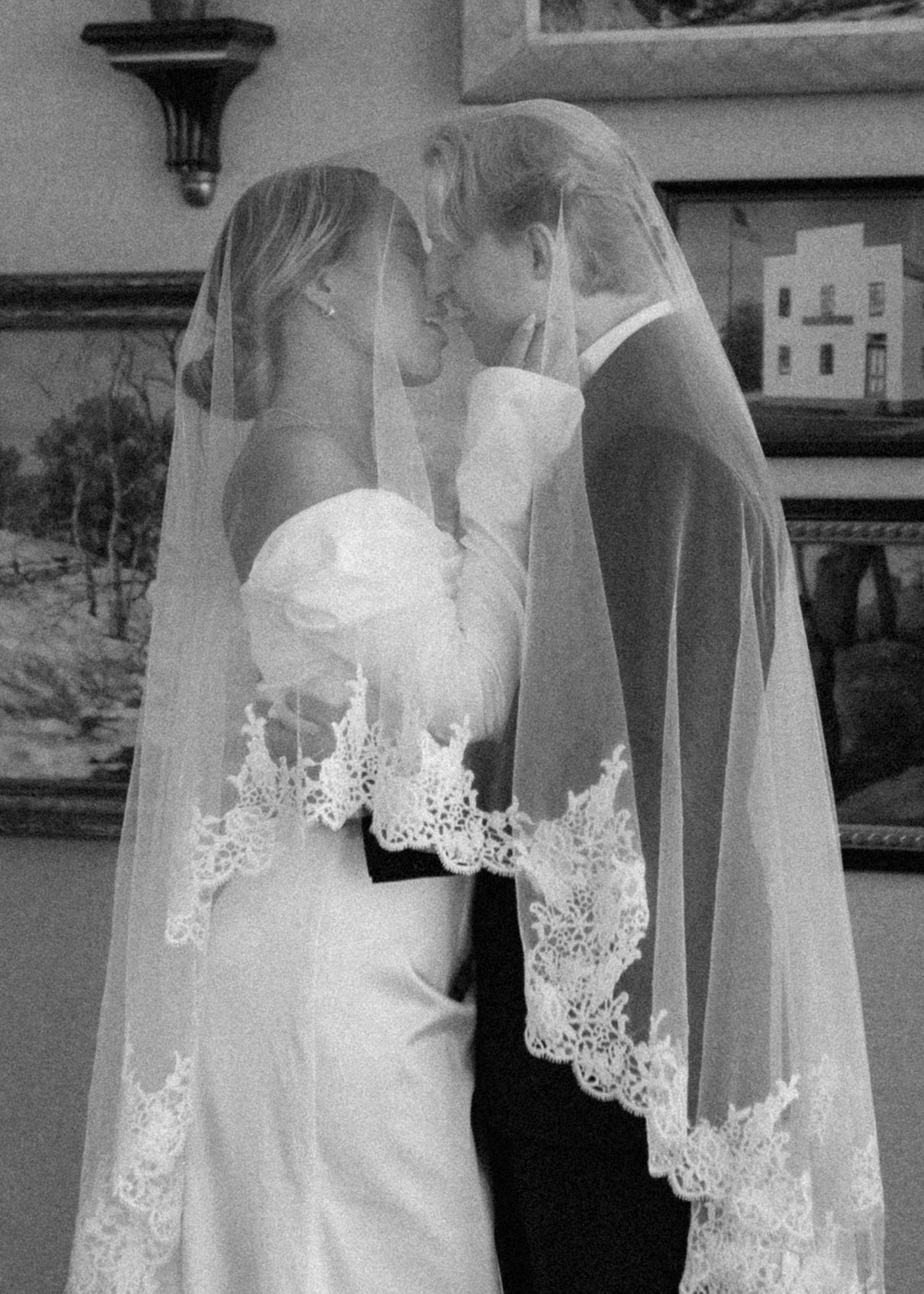 Close-up view of a delicate white wedding dress with lace trim and veil details. Appleton, Green Bay & Kaukauna