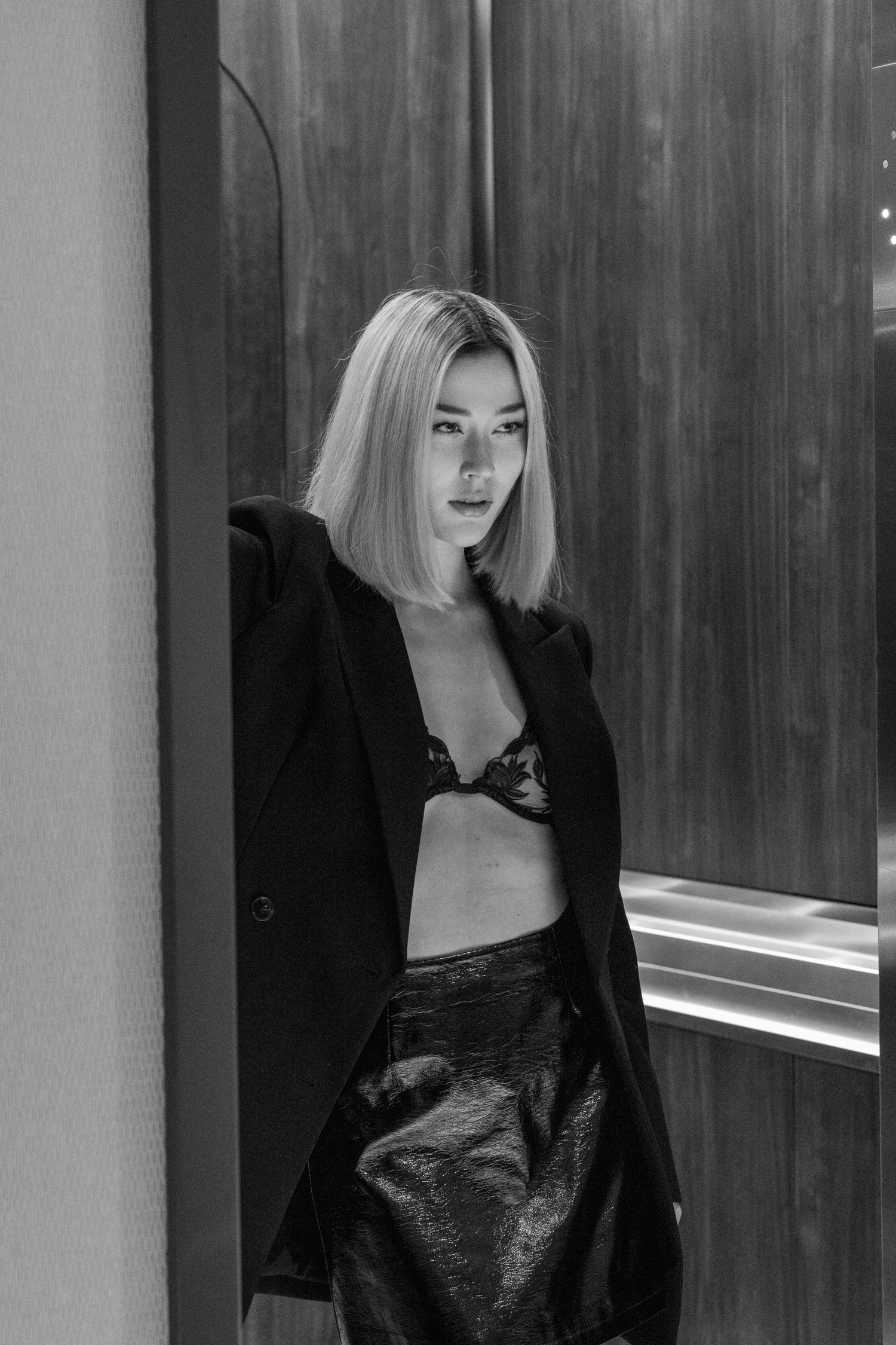 Fashion model wearing black blazer and leather skirt in stylish monochrome portrait. Calgary Alberta Branding Photographer.