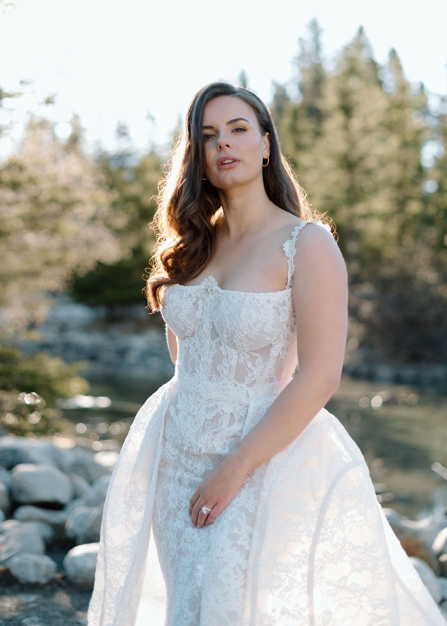 Detailed lace wedding gown with fitted bodice and full skirt photographed outdoors at Lake Louise. Calgary and Banff Wedding Photographer