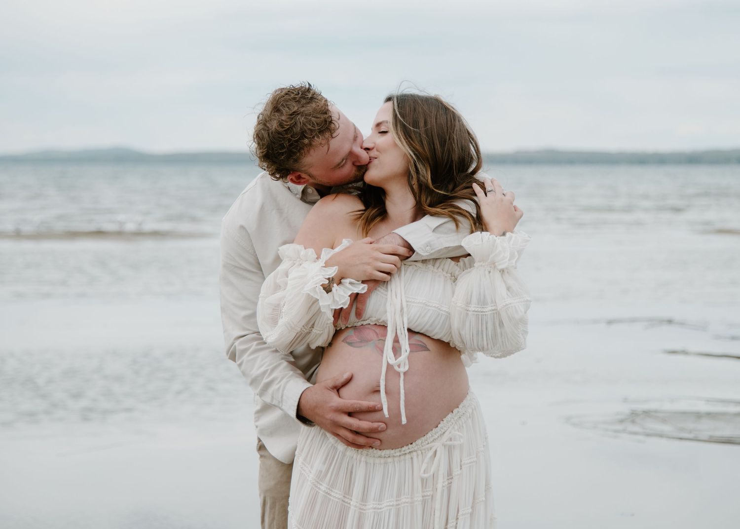 Soft and romantic beach maternity session with couple in flowing white garments. Calgary Alberta Maternity Photographer.