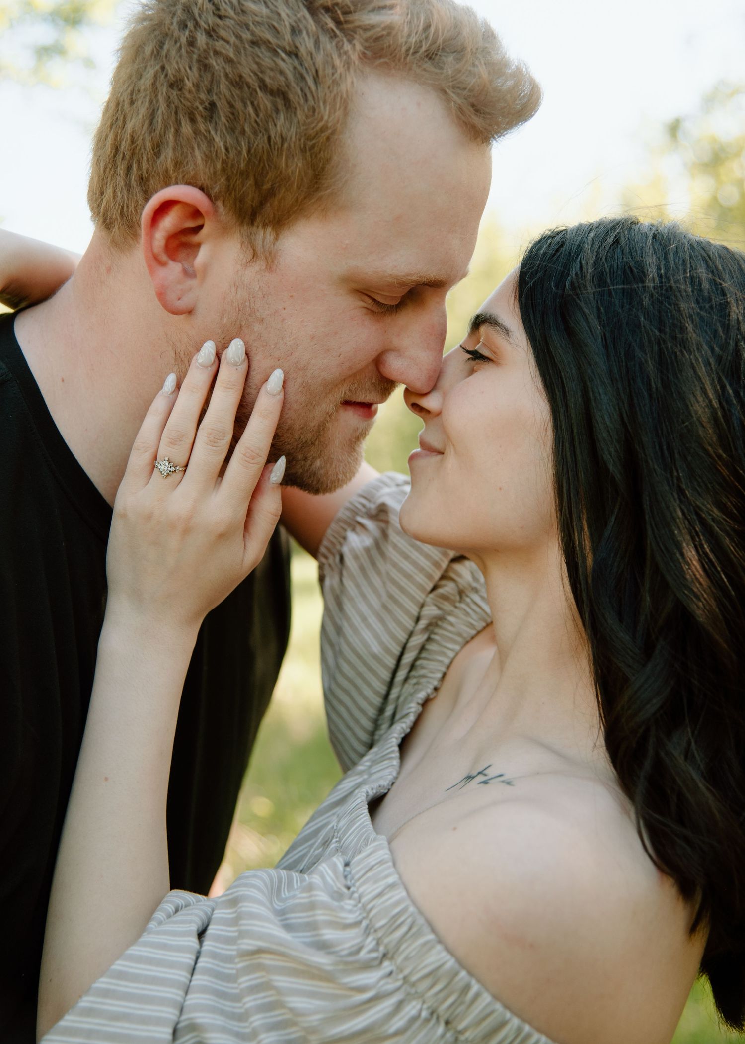 Intimate romantic moment captured between couple during outdoor photoshoot. Calgary Alberta Engagement Photographer