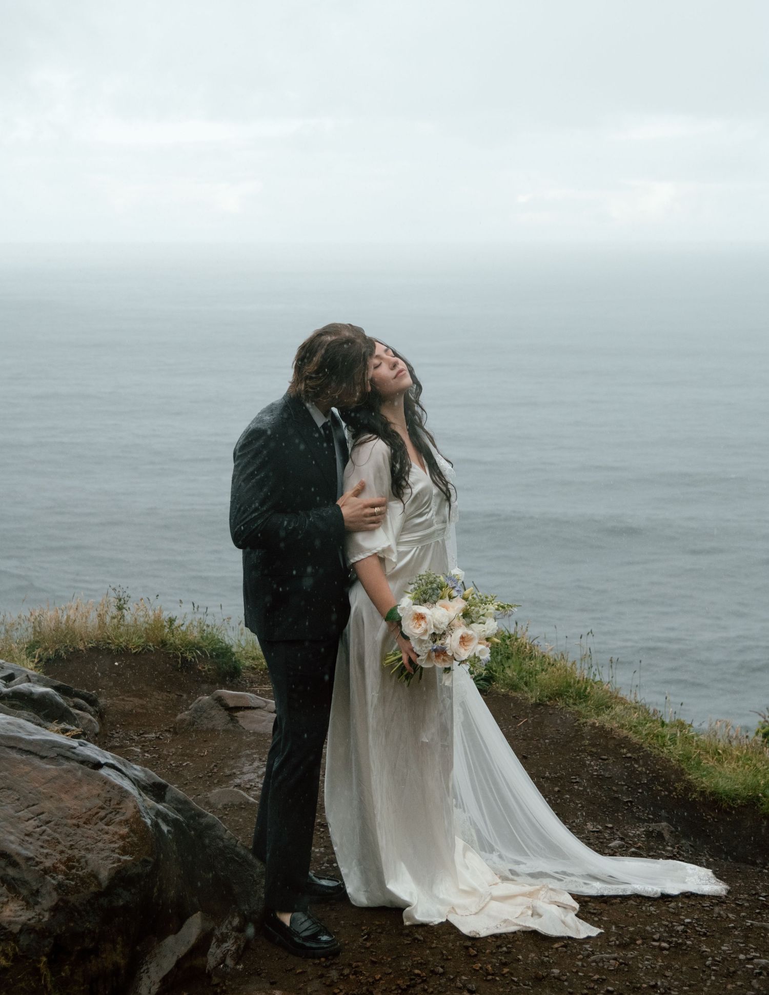 Artistic wedding photography sequence shows couple's romantic poses by ocean cliffside. Calgary Wedding Photographer