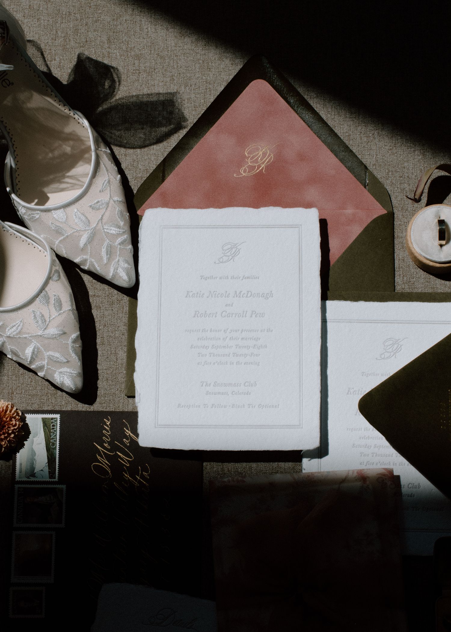 Wedding stationery suite featuring white invitations with pink envelopes and calligraphy details at the Studio at Vic Park YYC Wedding