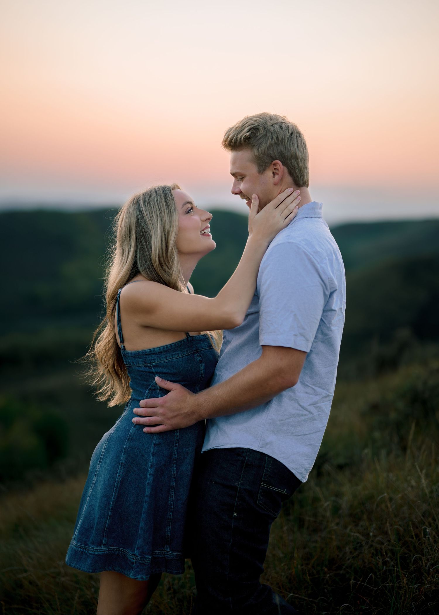 A romantic couple shares tender moments at sunset in a field, captured in a series of intimate poses.