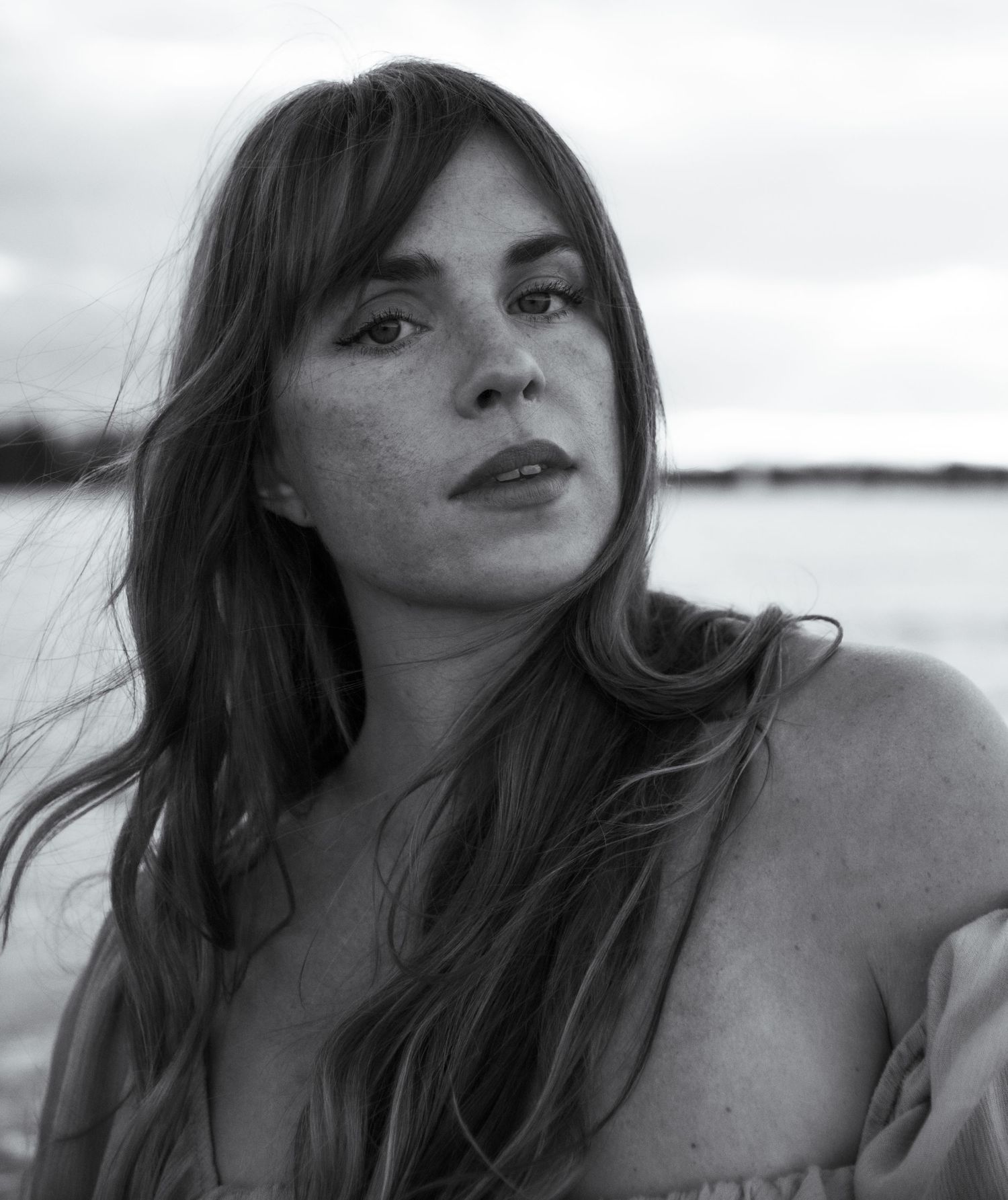 Intimate black and white portrait captured at sunset by a lakeside. Calgary Alberta Branding Photographer.