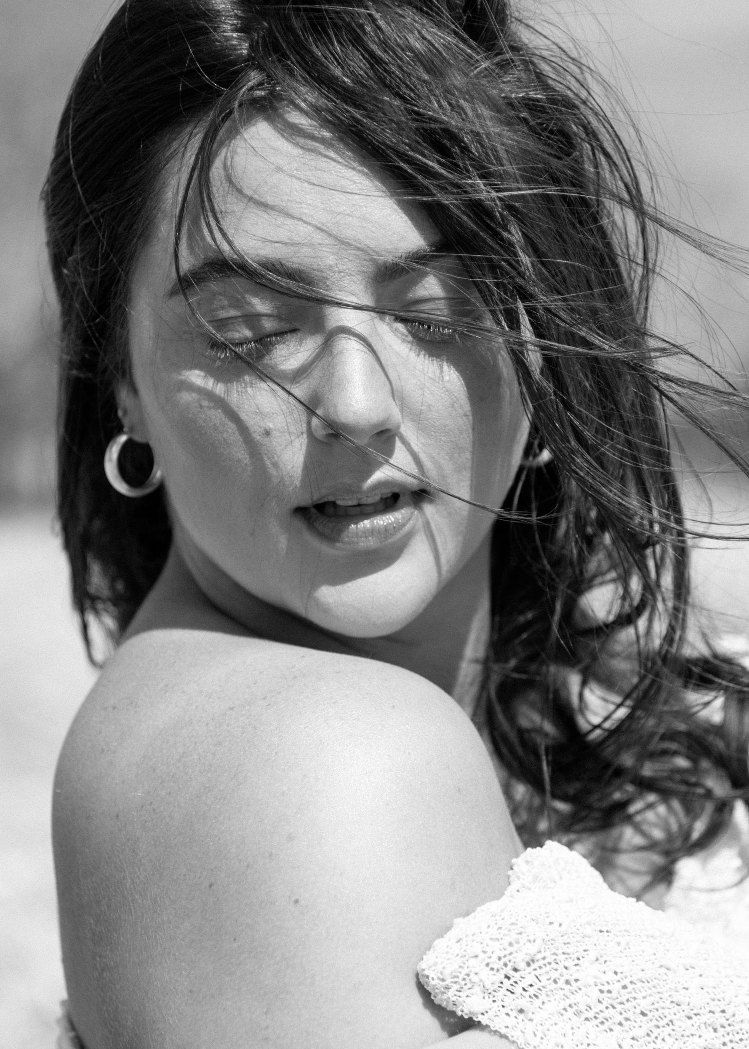 Black and white portrait showing woman with wind-swept hair in dramatic lighting. Calgary Alberta Branding Photographer.