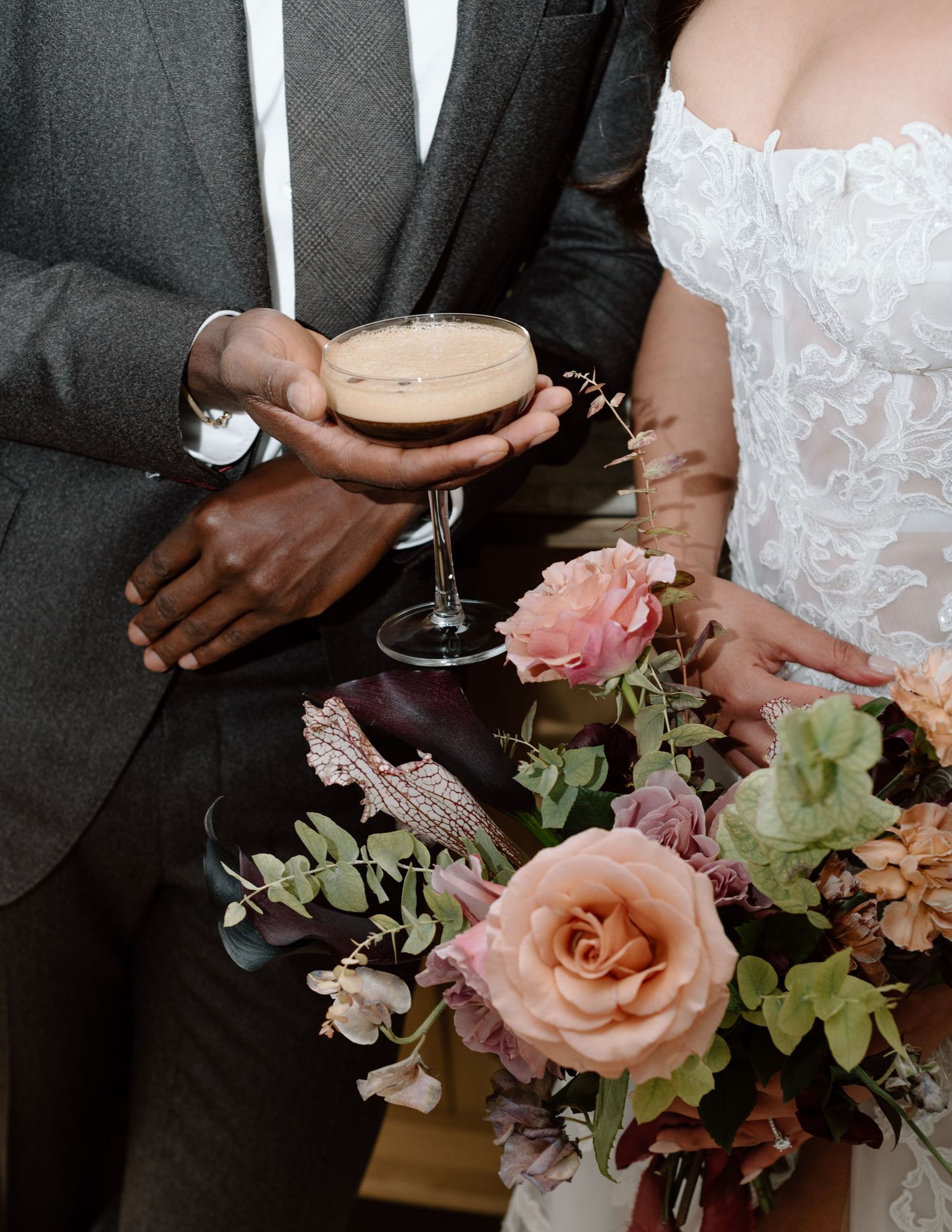 Close-up of champagne glass and pink roses with wedding attire details at the Studio at Vic Park YYC Wedding Photographer