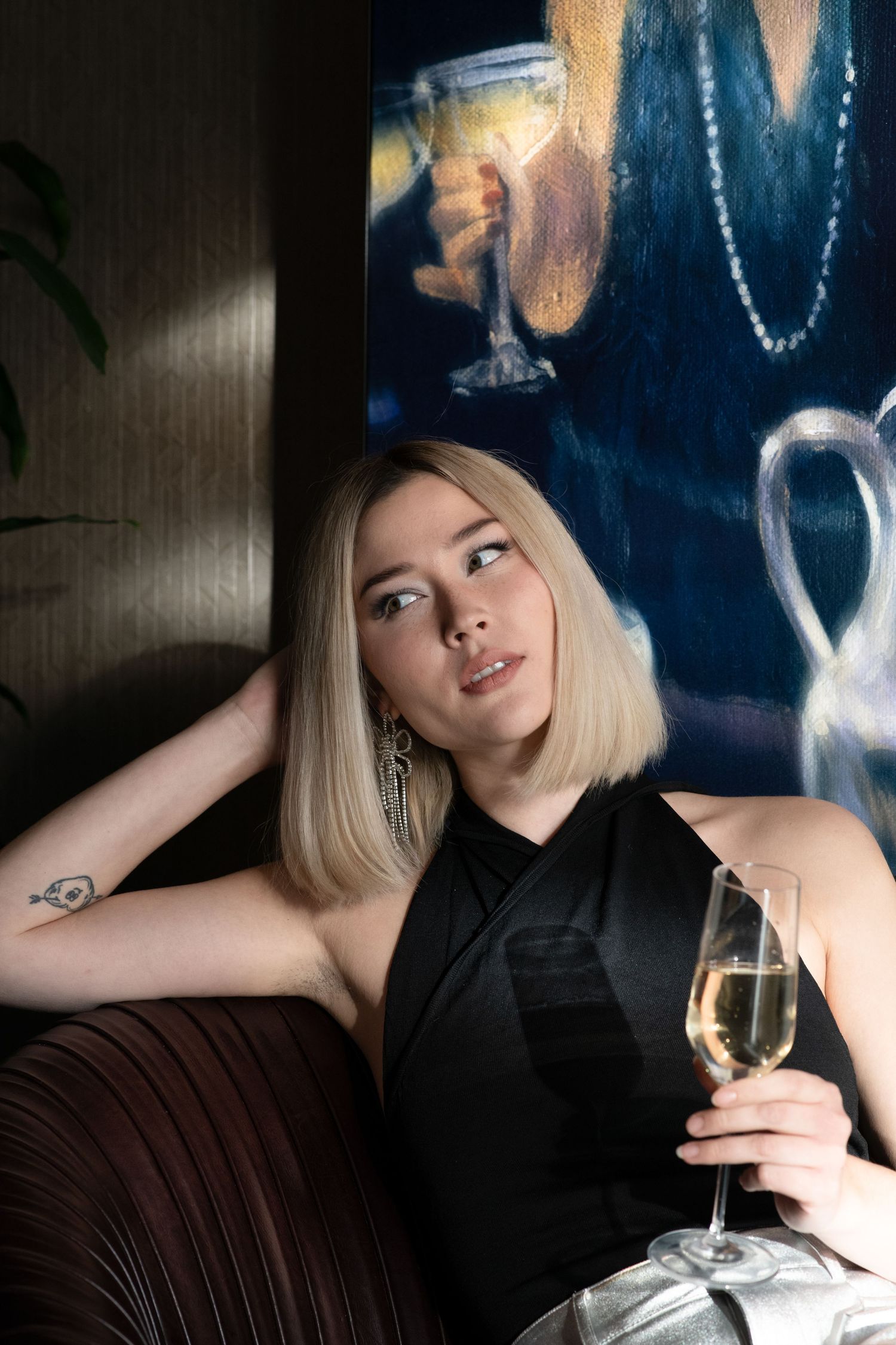 Elegant scene with wine glass and evening attire in moody lighting. Calgary Alberta Branding Photographer.