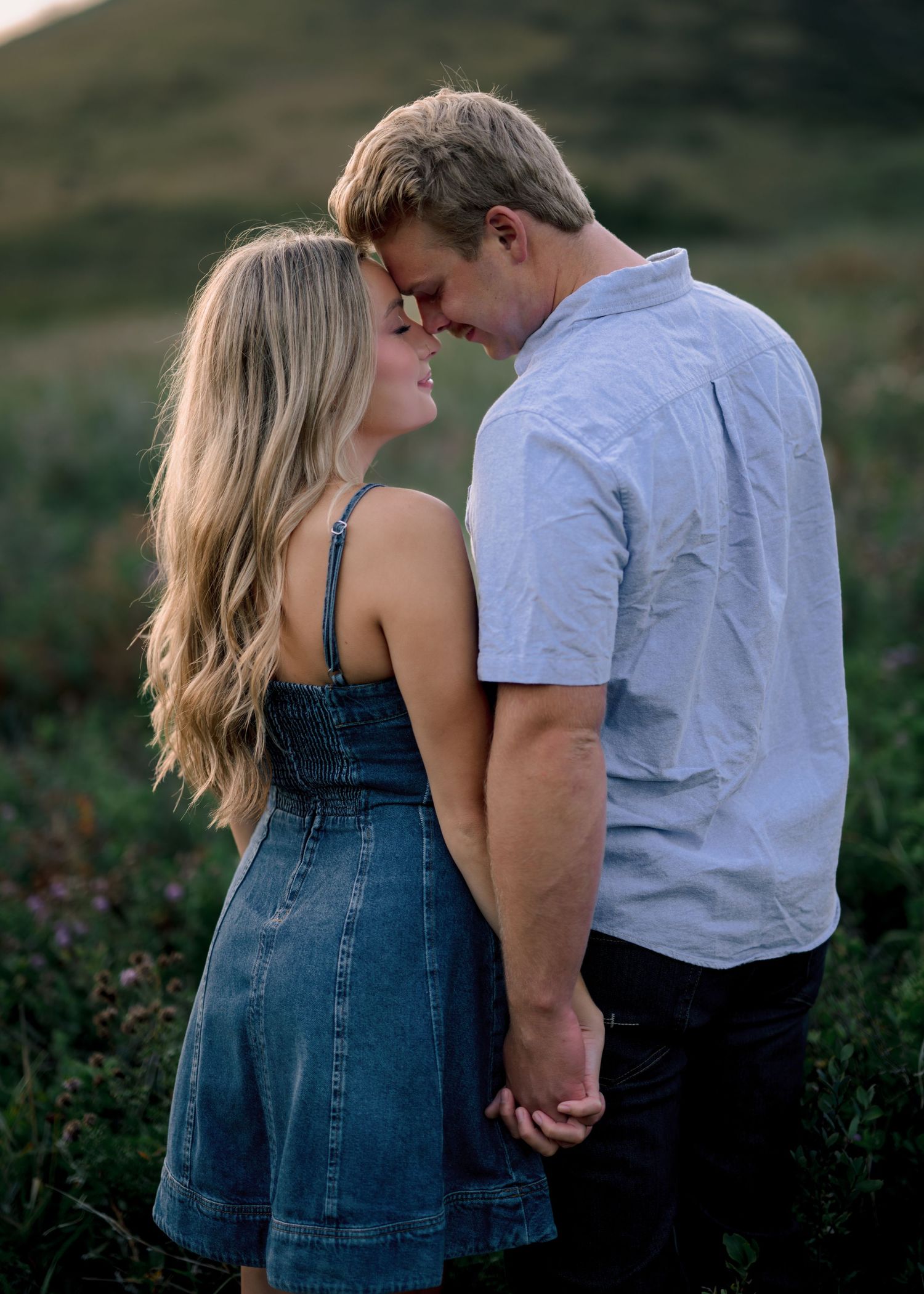 Couple in denim and white share intimate moments together in a romantic outdoor photo sequence.