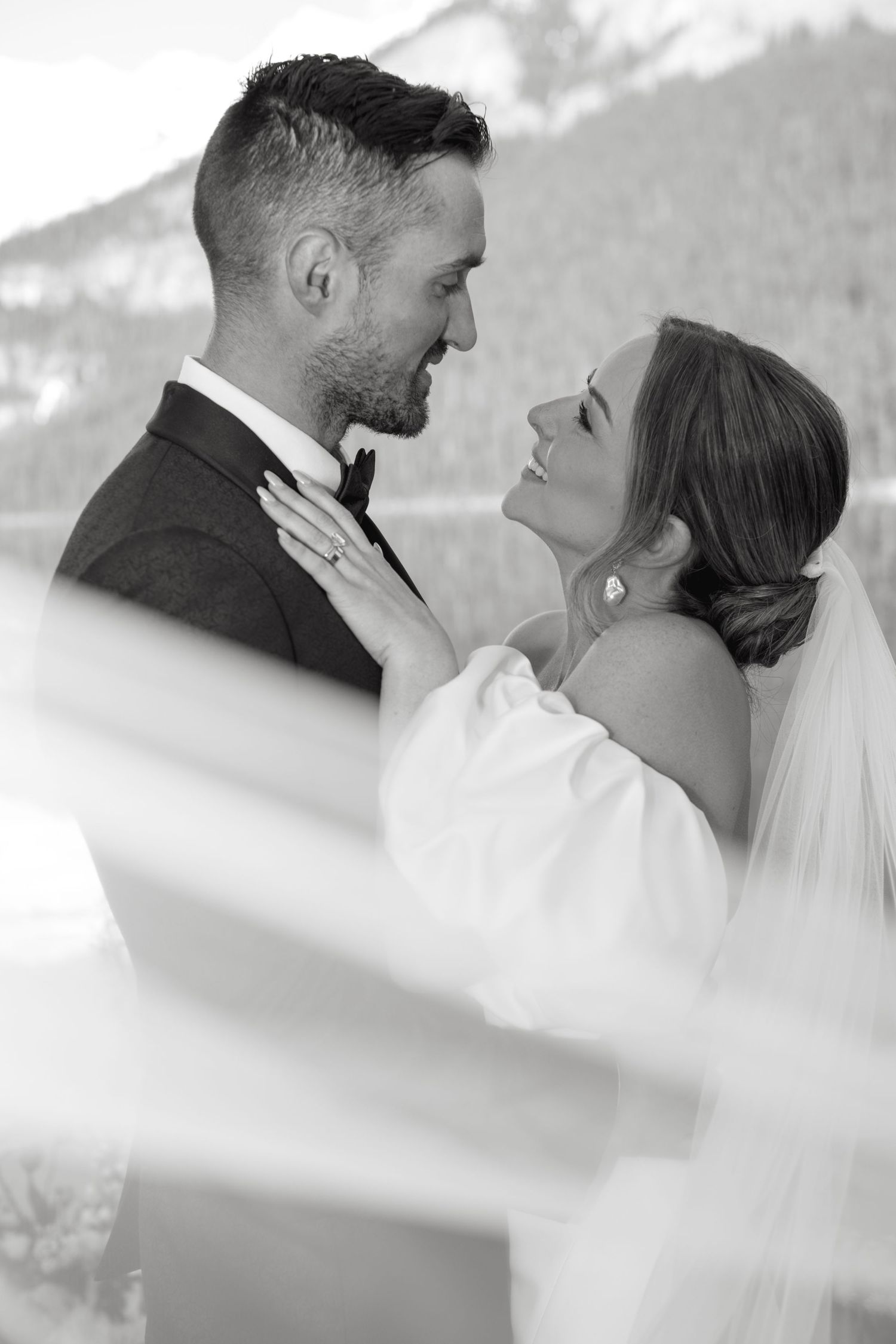 A romantic wedding photo sequence showing a couple in black and white sharing intimate moments with a veil.
