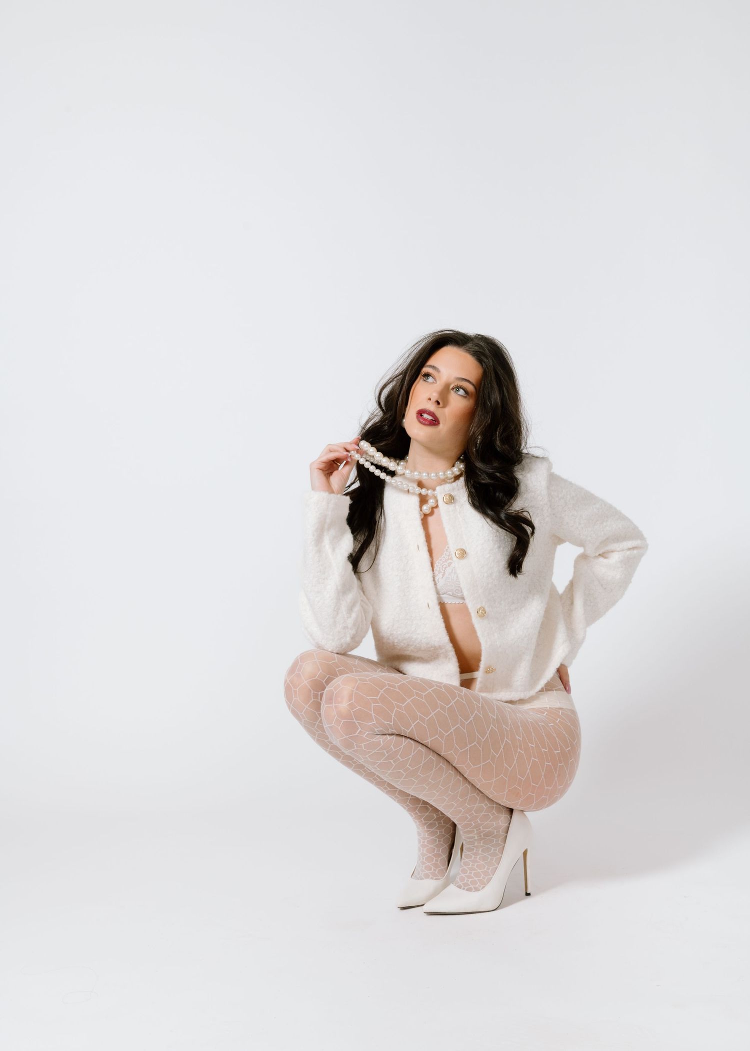 Fashion portrait in cream sweater and textured tights with minimalist styling. Calgary Alberta Bridal Boudoir Photographer.