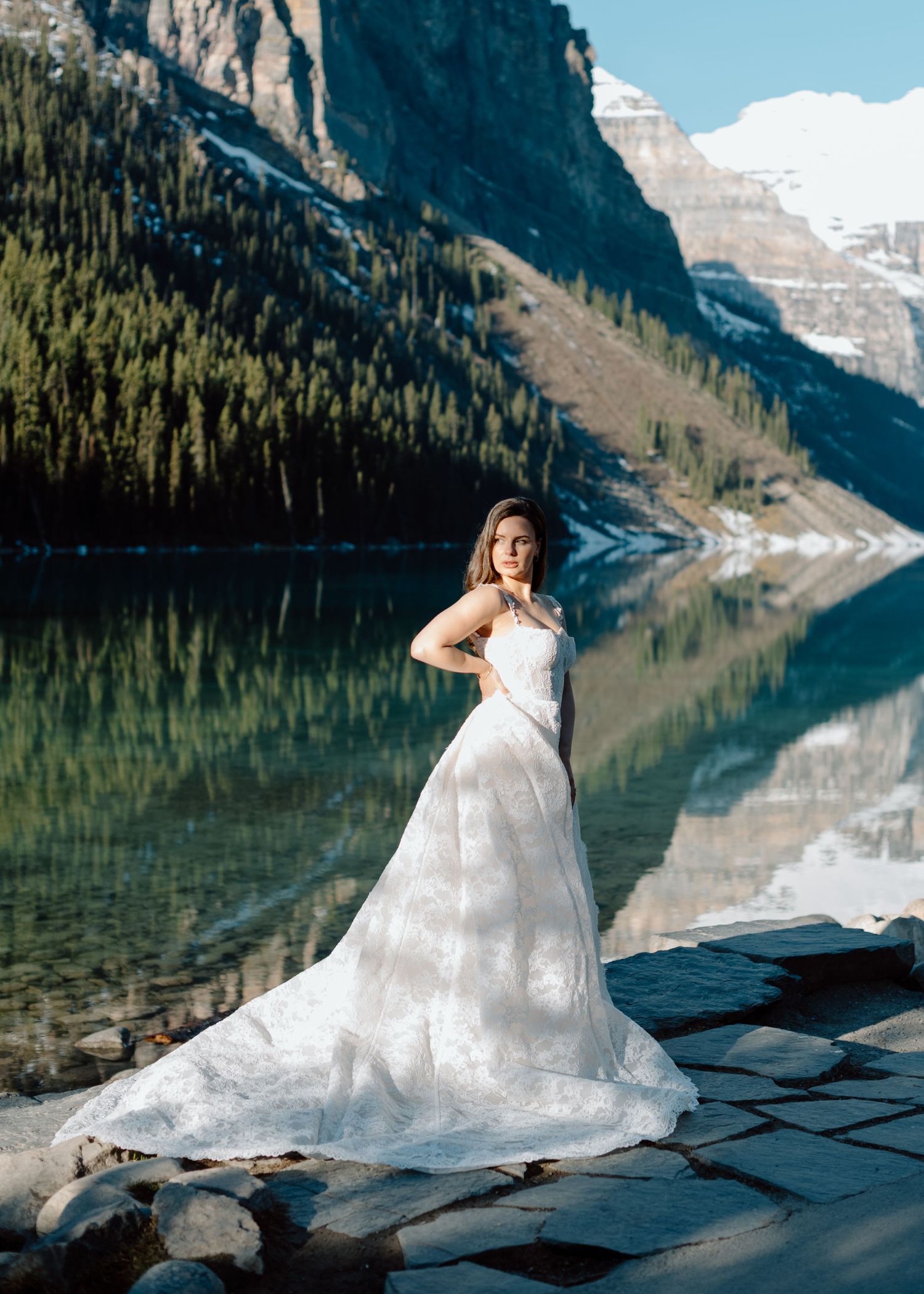 Beautiful wedding photograph taken at Lake Louise with mountain reflections in turquoise water. Calgary and Banff Wedding Photographer