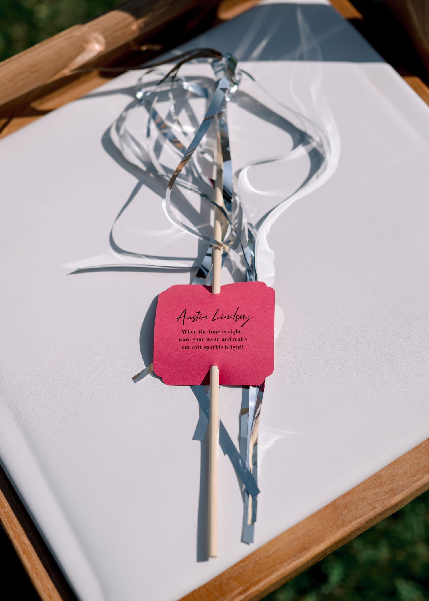 Red bird-shaped clay ornaments hang from white and silver branches in a minimalist decorative arrangement.