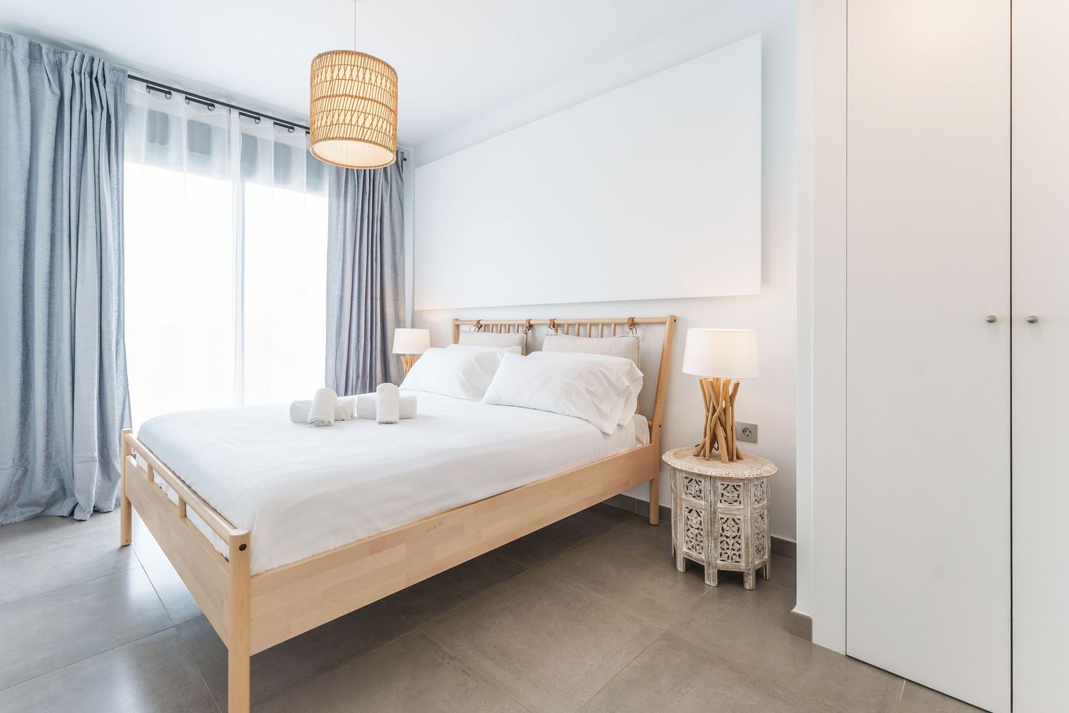 Modern coastal bedroom photographed in Santa Pola for a real estate listing. Natural light and minimalist interior for property promotion.