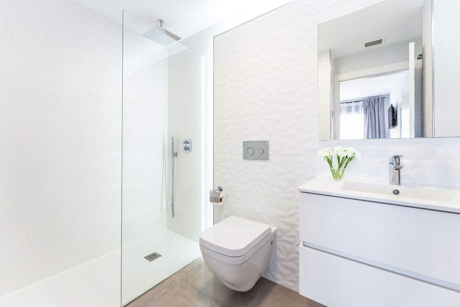 Minimal white bathroom interior in Alicante. Real estate and interior photography with clear lighting and well-styled spatial flow