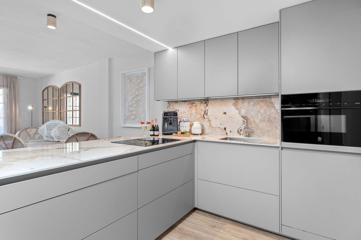 Contemporary kitchen space photographed in Altea for real estate marketing. Sleek finishes and clean layout with natural light.
