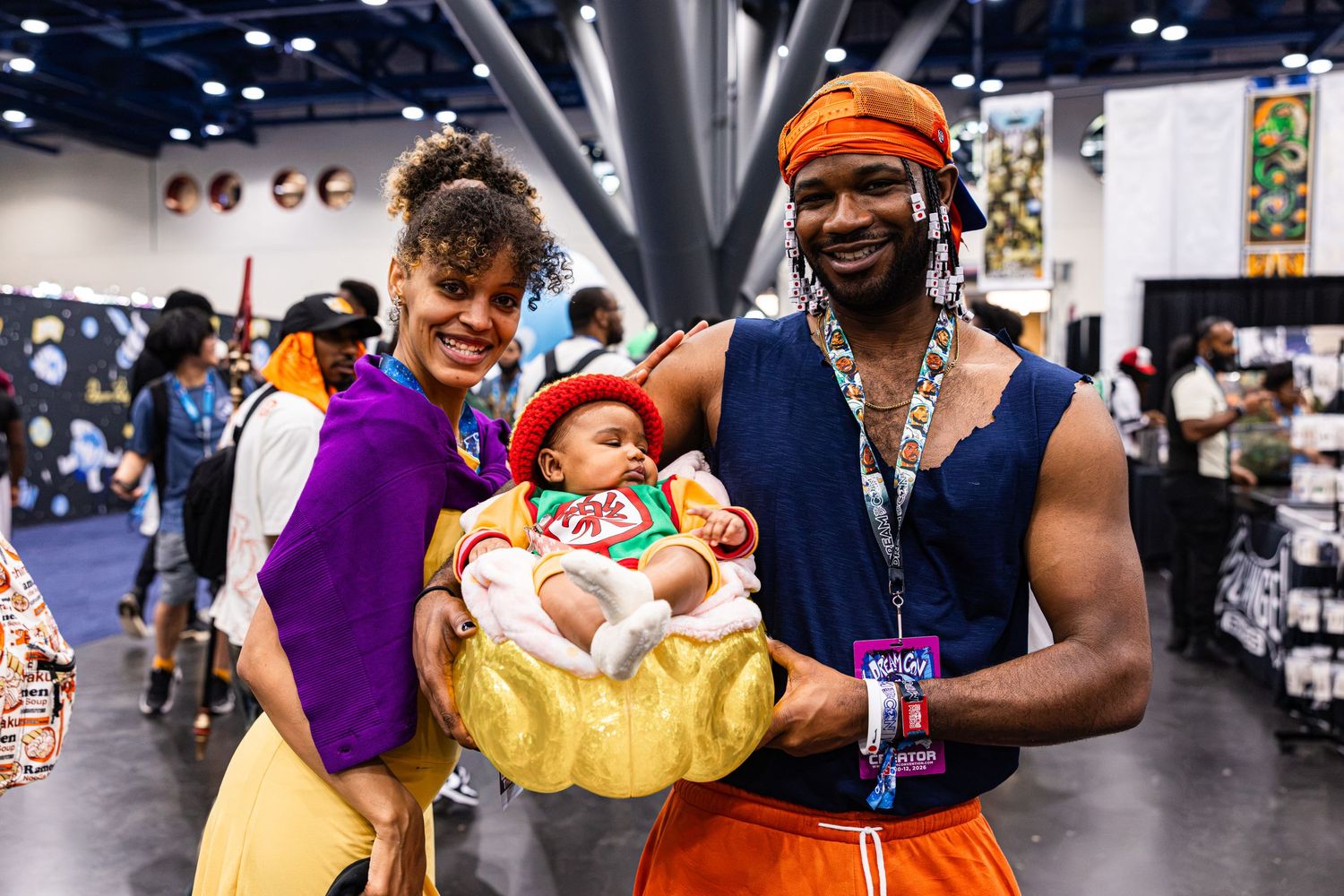 Family cosplaying as Aladdin characters at a comic convention, with baby dressed as a pearl in a clamshell.