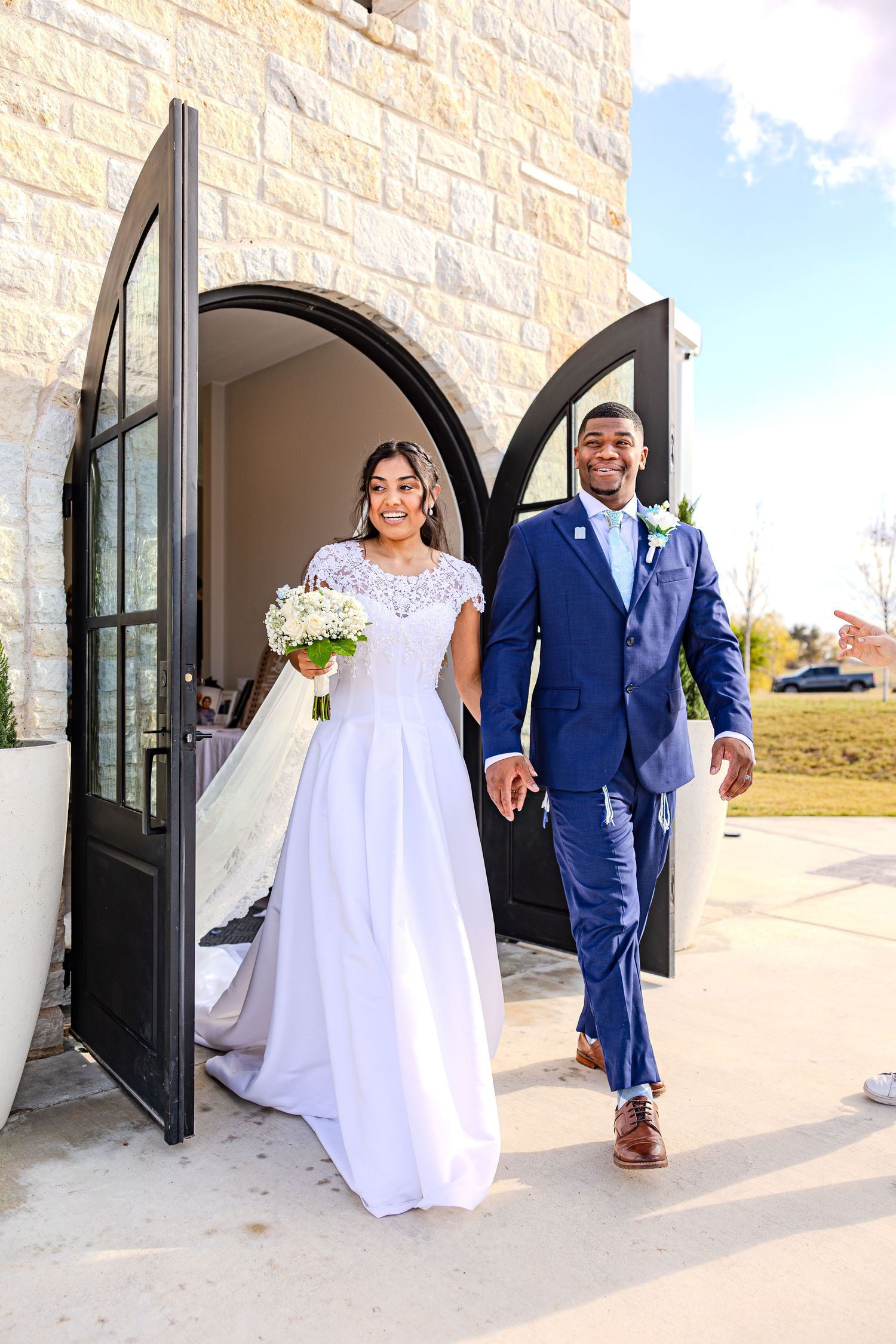 Wedding couple exiting church through arched doorway in sequence of celebratory shots.
