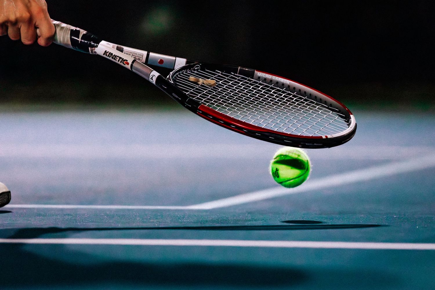 A sequence of tennis action shots showing a ball, racquet and player movements on a blue court surface.