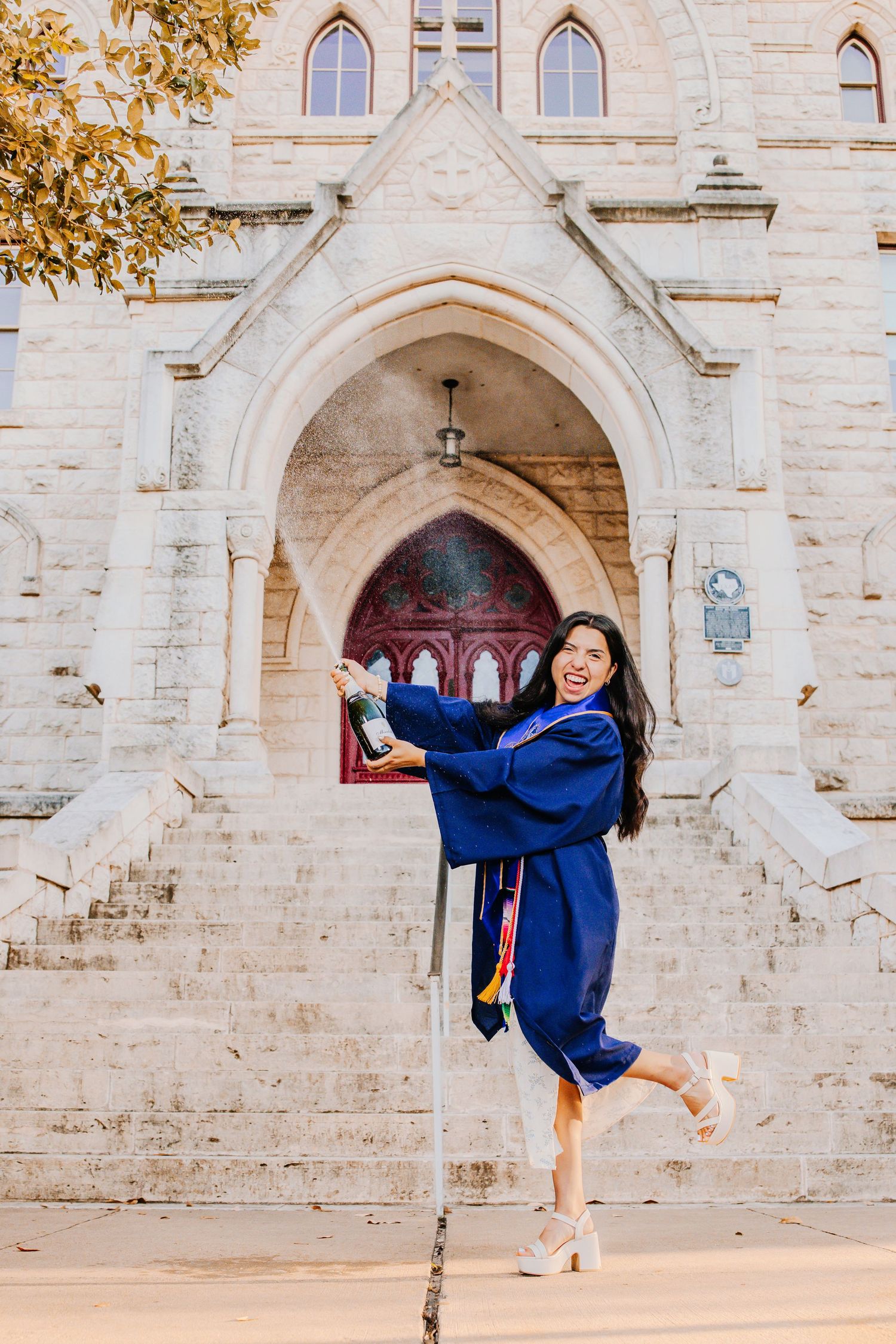Graduation photoshoot sequence in front of gothic stone church architecture.